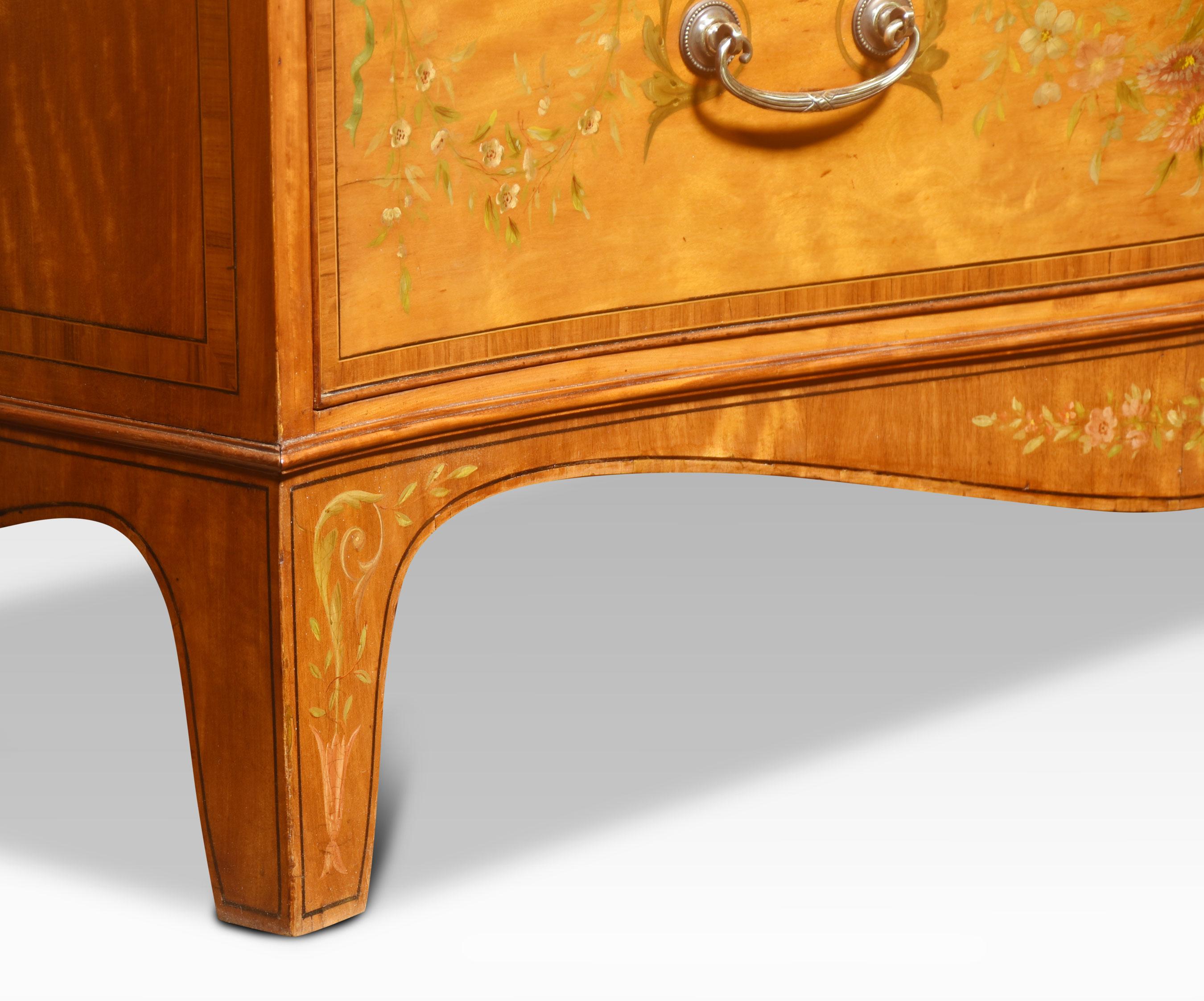 Satinwood chest of drawers, the large rectangular serpentine top having floral painted banding above three long graduated drawers with further painted detail and brass handles. All raised up on splayed bracket feet.
Dimensions
Height 36.5