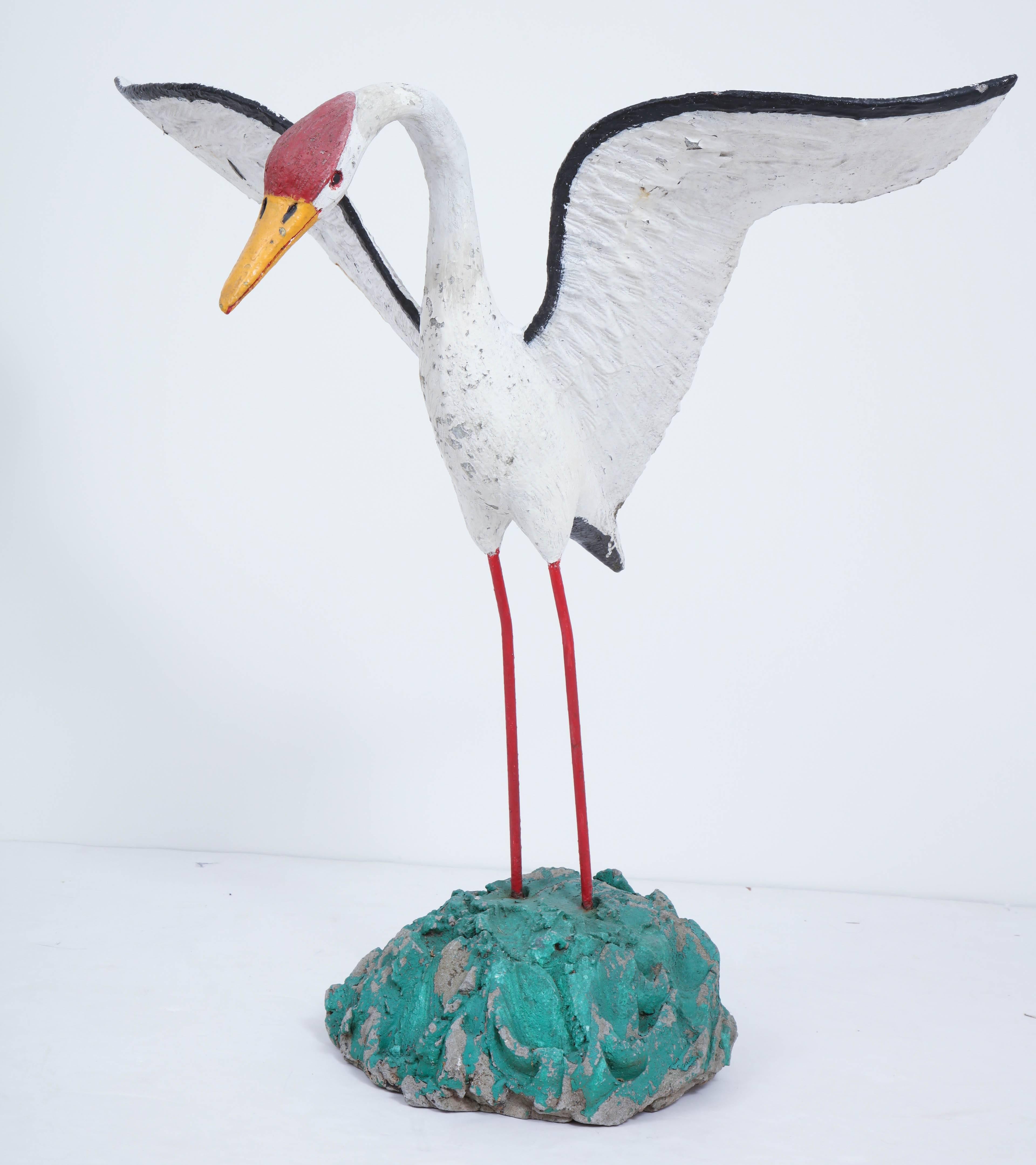 Painted seagull sculpture with large wingspan.