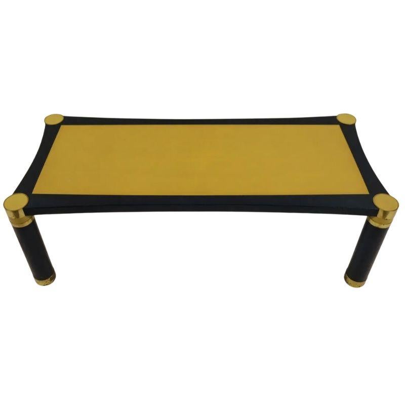 A mid-century coffee table attributed to the legendary Karl Springer. Crafted of a painted blue and yellow snakeskin, it boasts a mod 1970's/10980's aesthetic. Atop the table rests a vibrant yellow hue bordered in a deep blue, creating a striking