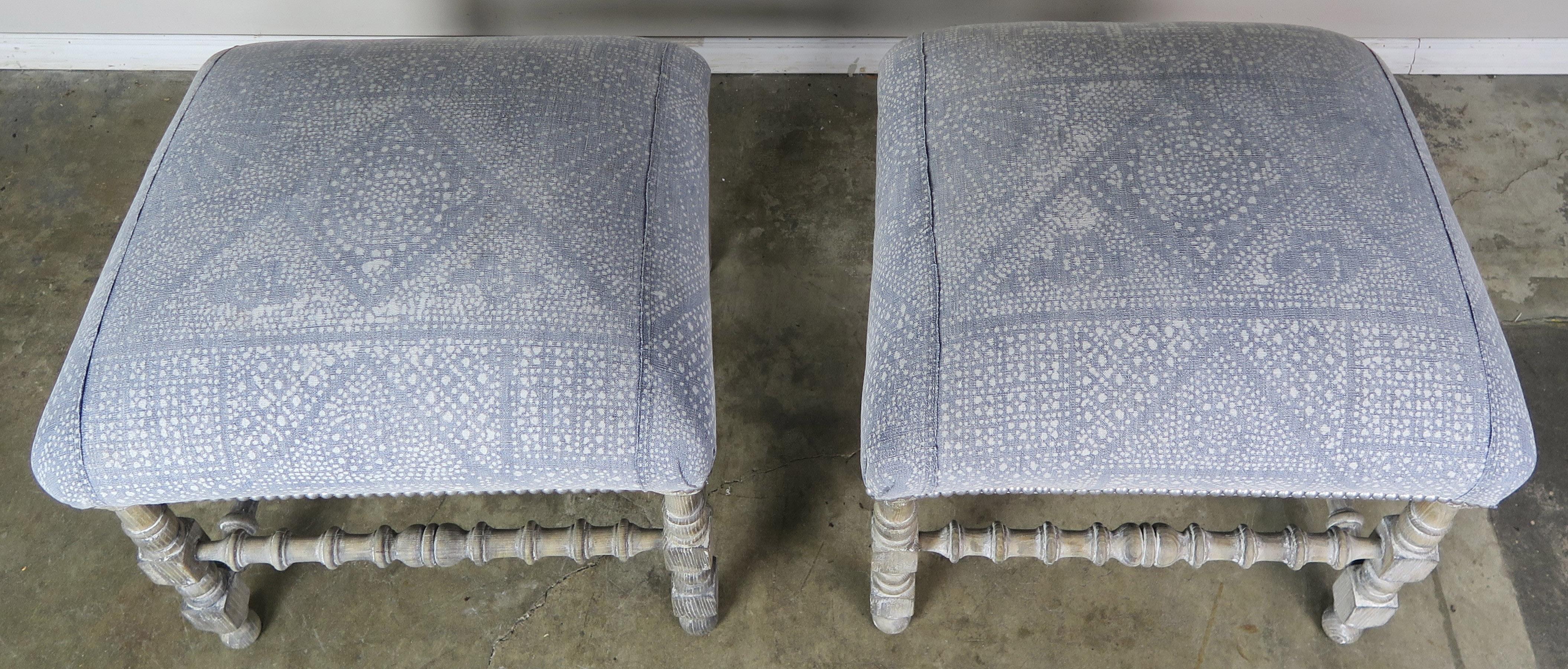 Pair of washed painted Swedish benches upholstered in a washed blue & white batik cotton textile and finished with silver colored nailhead trim detail.