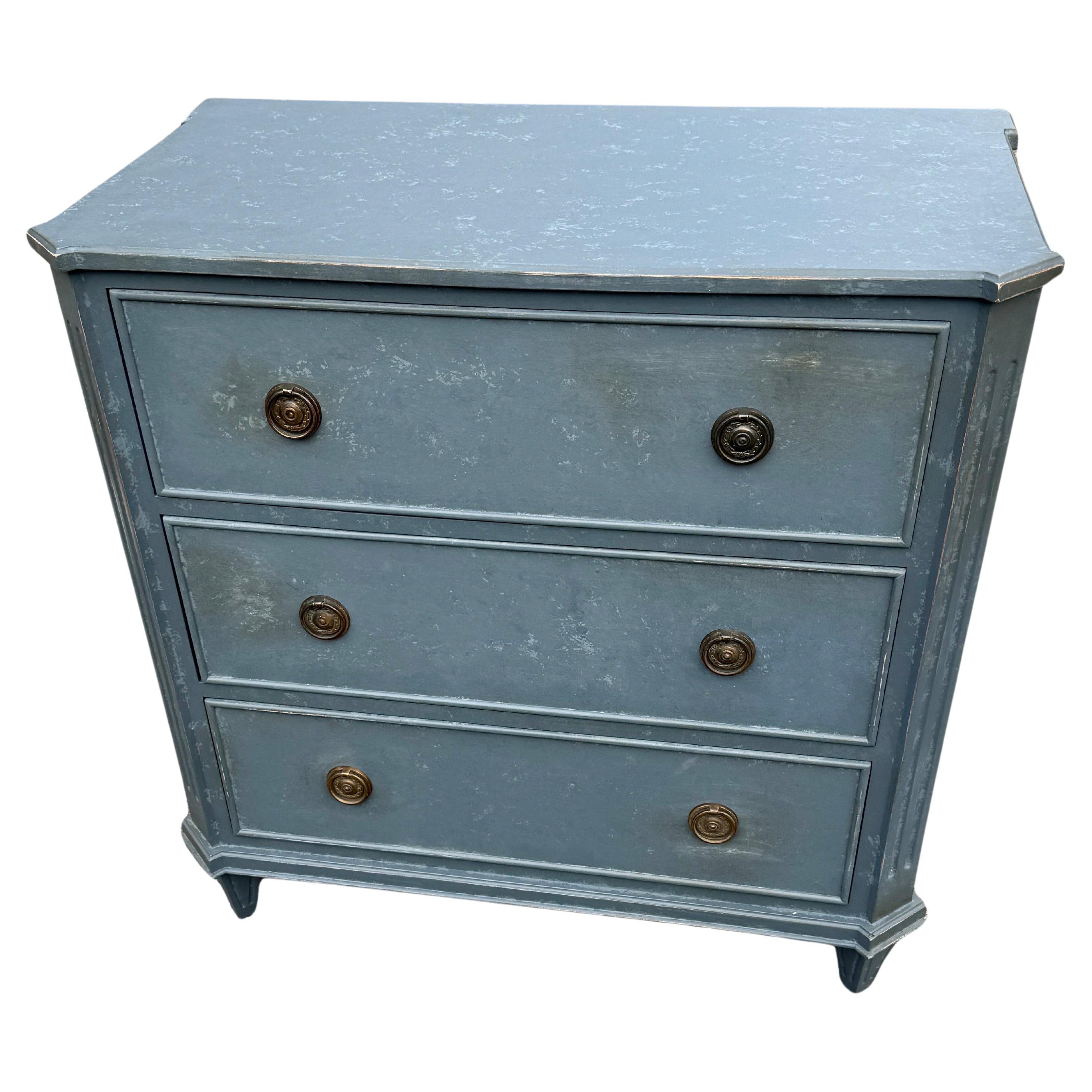 Petroleum Blue Painted Gustavian Style Chest of Drawers

This classic Swedish style three drawer hand-painted chest has been constructed from solid wood with a hand-applied distressed finish and features brass ring hardware. The chest, based on a