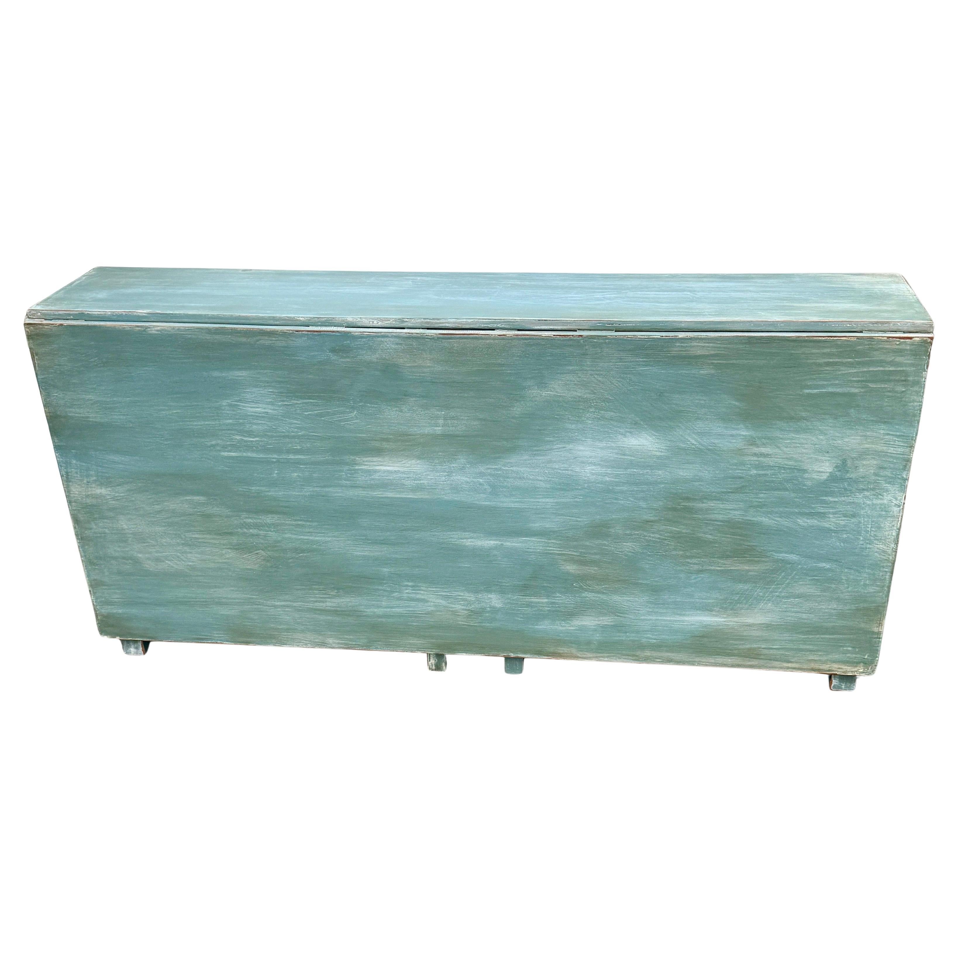 Swedish Gustavian Style Painted Drop Leaf Table. This table is a marvel of ingenuity. Hand-crafted, it features two huge leaves that drop down out of the way when not needed, making this a great choice as a behind sofa or hall table. When a dining