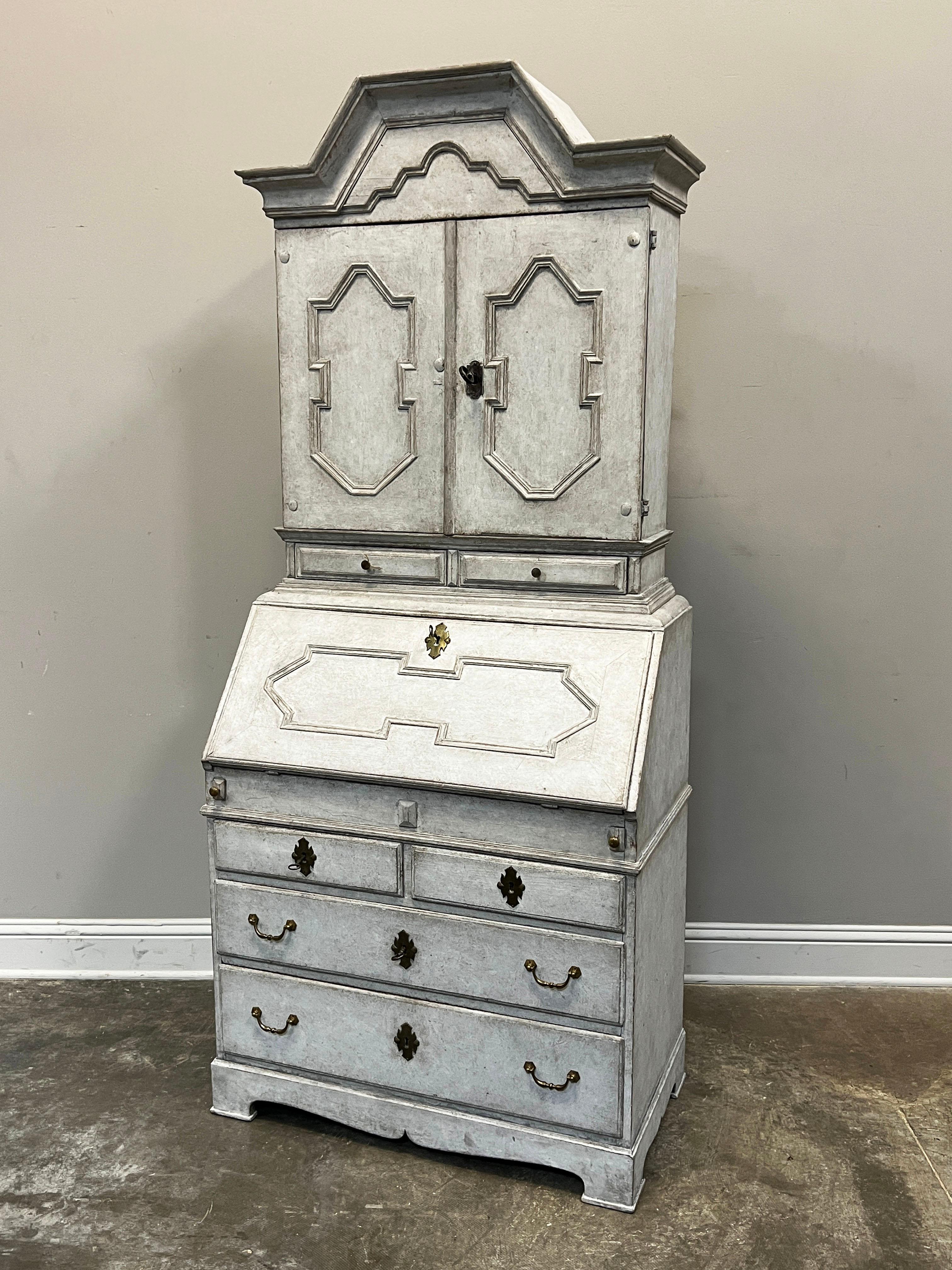 Really beautiful Swedish secretary with drop front, interior drawers, cubbies and a secret compartment. Two doors sit on two drawers on the top and there are two small drawers over two large drawers on the bottom. The piece is decorated with lozenge