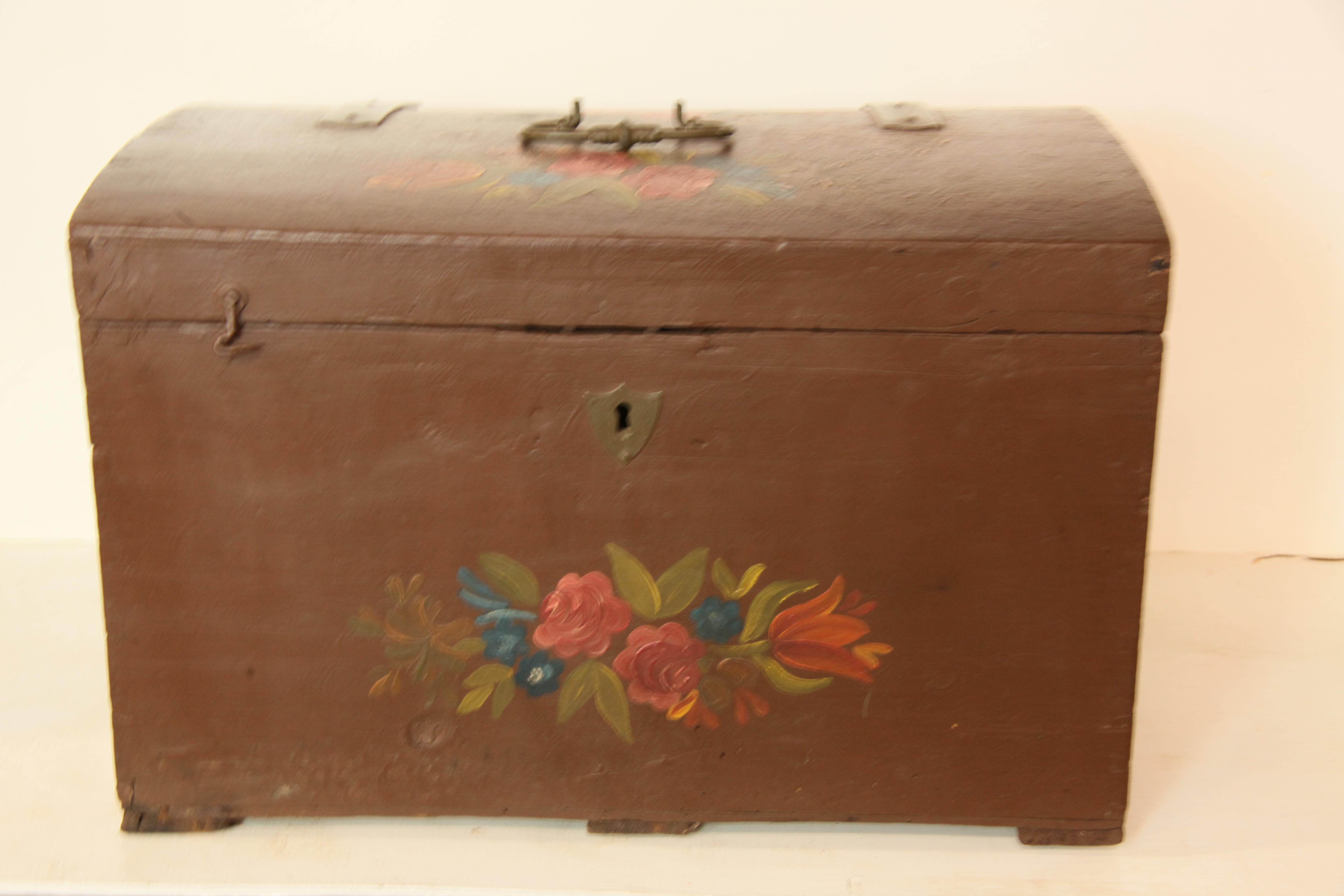 Painted Swedish trunk,  the dome top with painted flowers and foliage, steel strap hinges and center steel handle.  The front and sides have similar floral decoration.  
