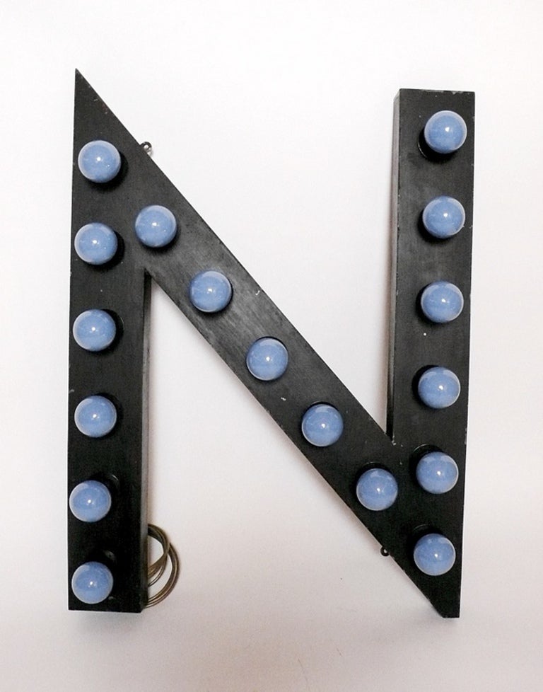 Painted tin letters, black color, rewired with bulbs, used for a theater sign. Ten pieces are available. The light bulb attacks have been rewired for the US and the Letters are priced and sold separately.