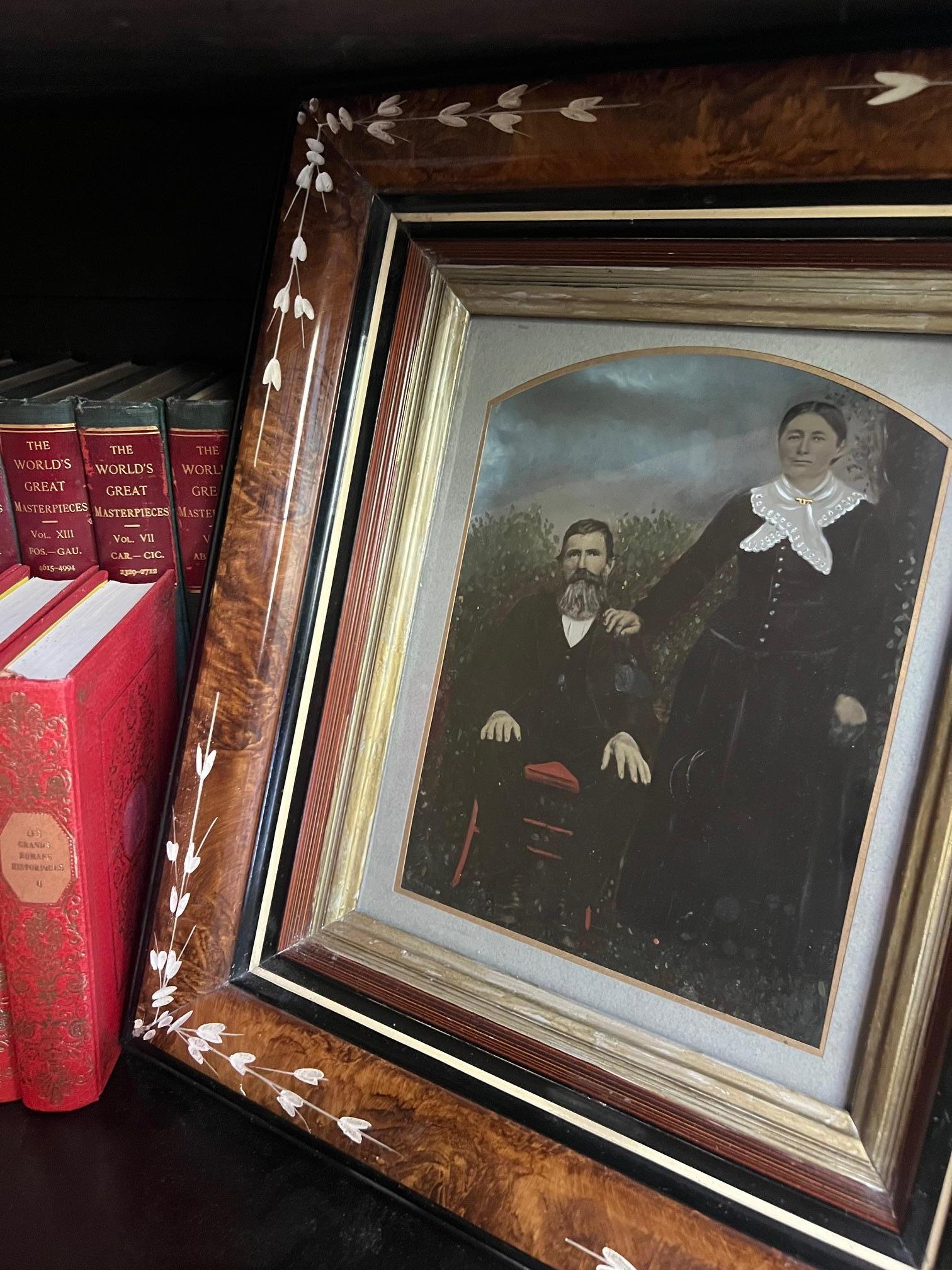 Antique tintype photograph of couple that has been painted. The painted tintype has been deeply inset in a Victorian Eastlake frame.