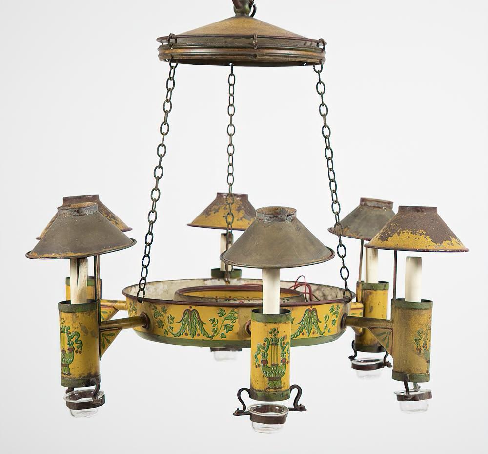 A yellow and green painted and decorated tole 6-light chandelier with shades and drip cups.