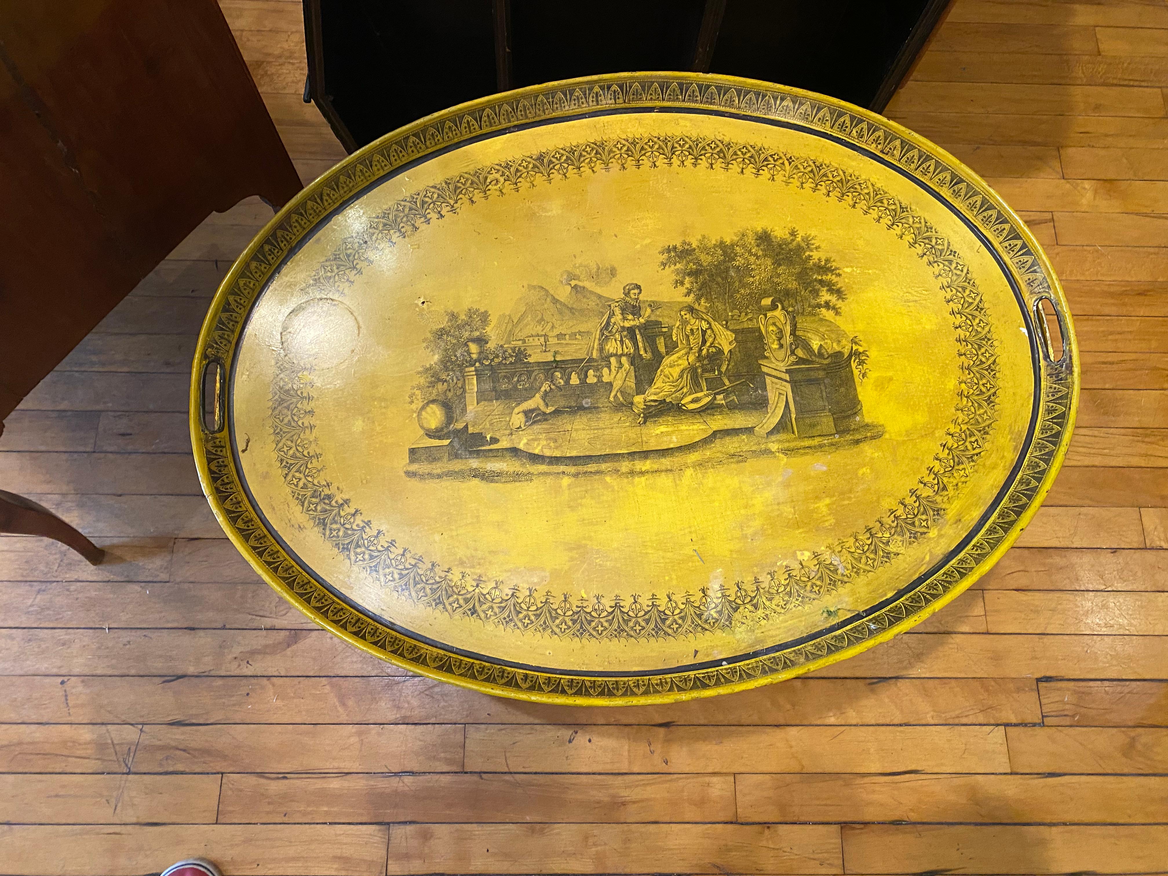 Painted tole tray on an ochre ground, mounted on a bespoke, faux bamboo, later wooden stand,the central reserve showing Vesuvius and the BA Charles X style oval transfer decoratay of Naples. 