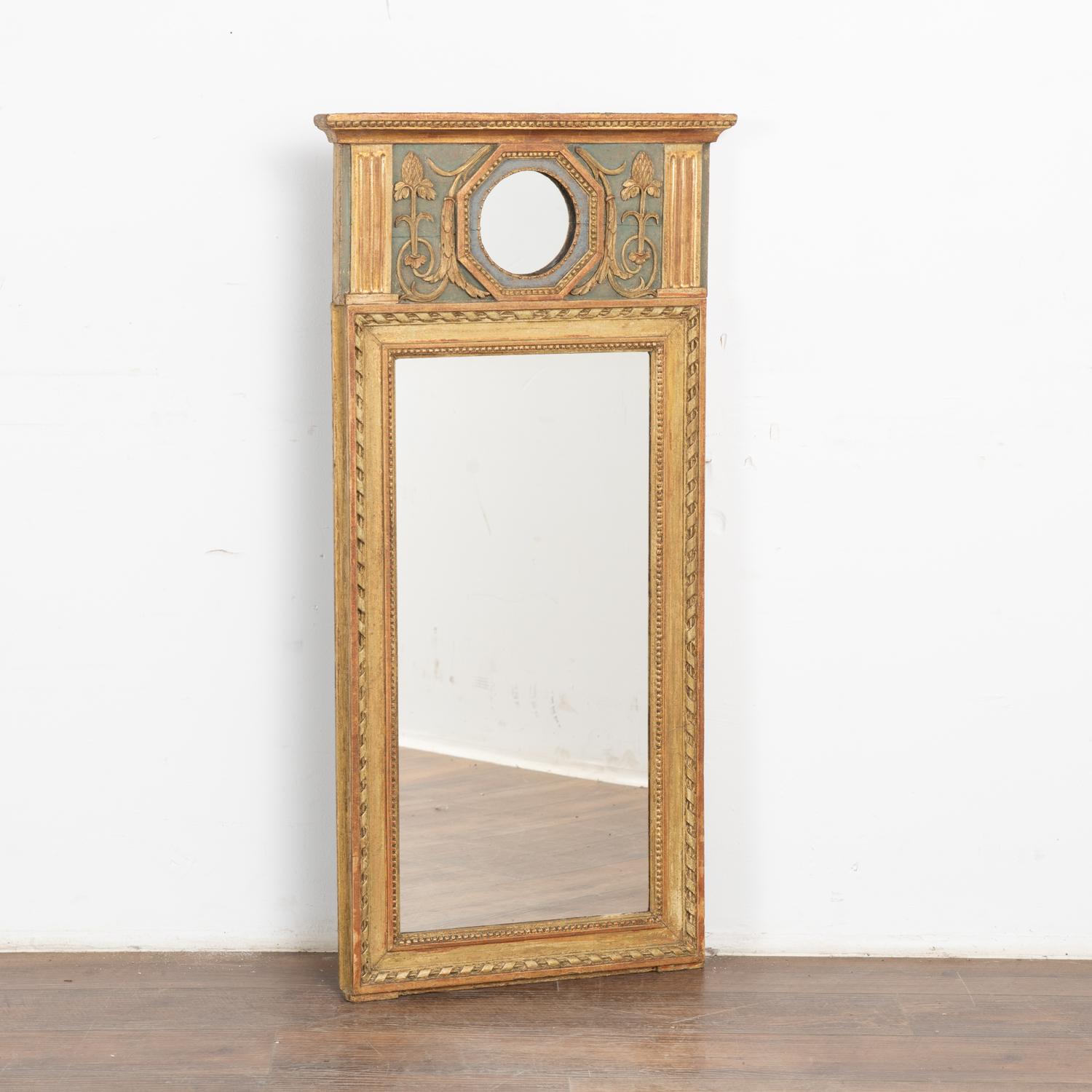 Lovely trumeau mirror with upper painted and carved thistle design and smaller octagon shaped mirror create a striking crown.
Beautiful shades of gold, antique white, muted red and pale blue are seen throughout accenting the delicate carved