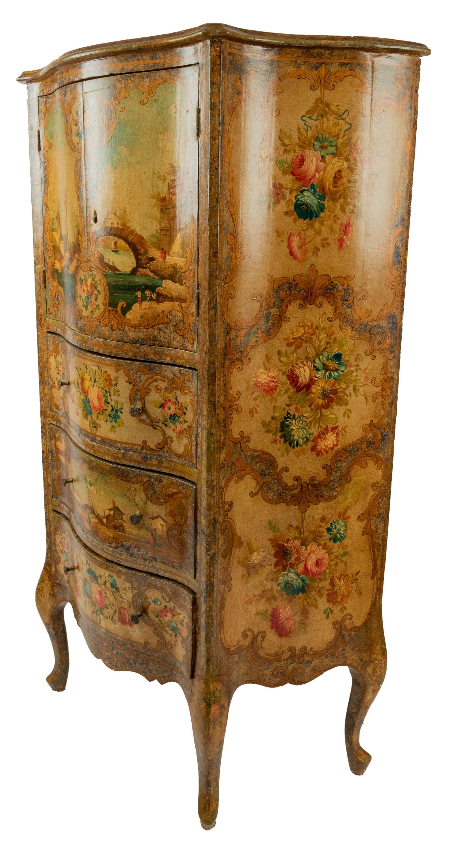 A Venetian dresser with three drawers surmounted by a large cabinet painted with scenes of floral sprays and ancient ruins.
