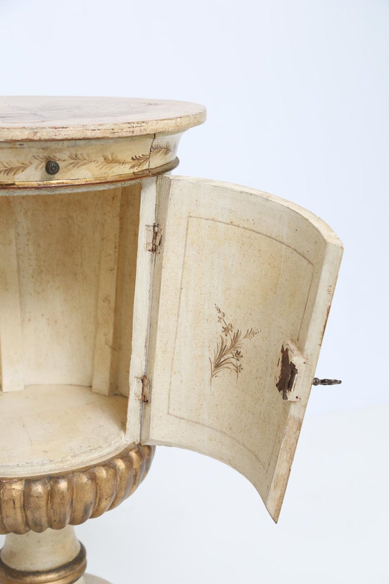 Pot stand pedestal table, having distressed painted finish with gilded detail, beautifully hand painted landscape scenes and florals, round top, single drawer over cupboard door (with key), raised on octagonal base.

Stock ID: D2495.