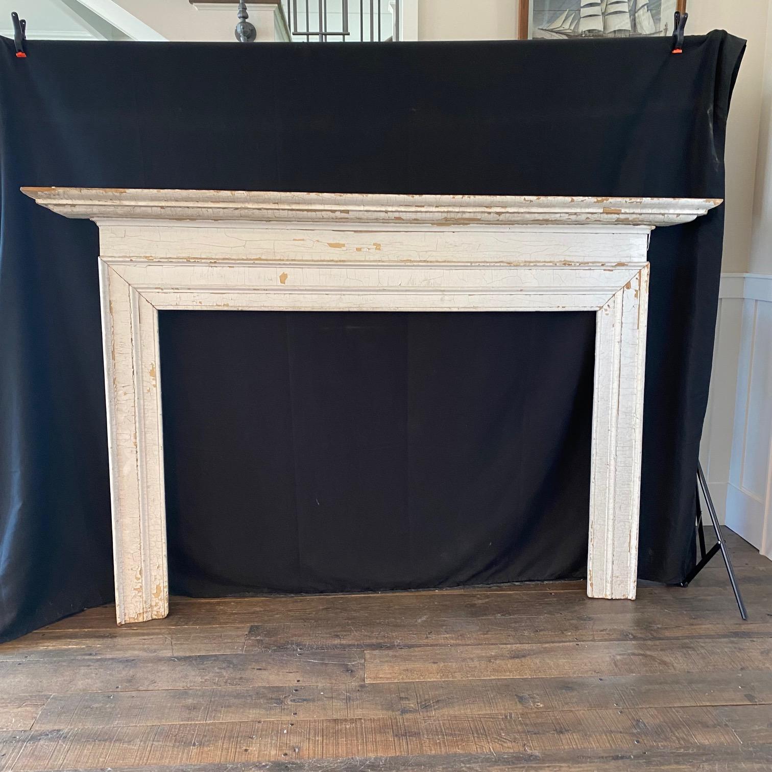 This elegant yet simple distressed ivory white painted wood fireplace mantel has lovely detailed mouldings. As found in Maine. 
 #5291


 H opening 39” W opening 55.25”.