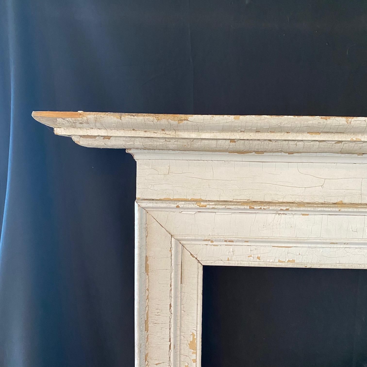 American Painted White Distressed Antique Fireplace Mantel with Detailed Mouldings For Sale