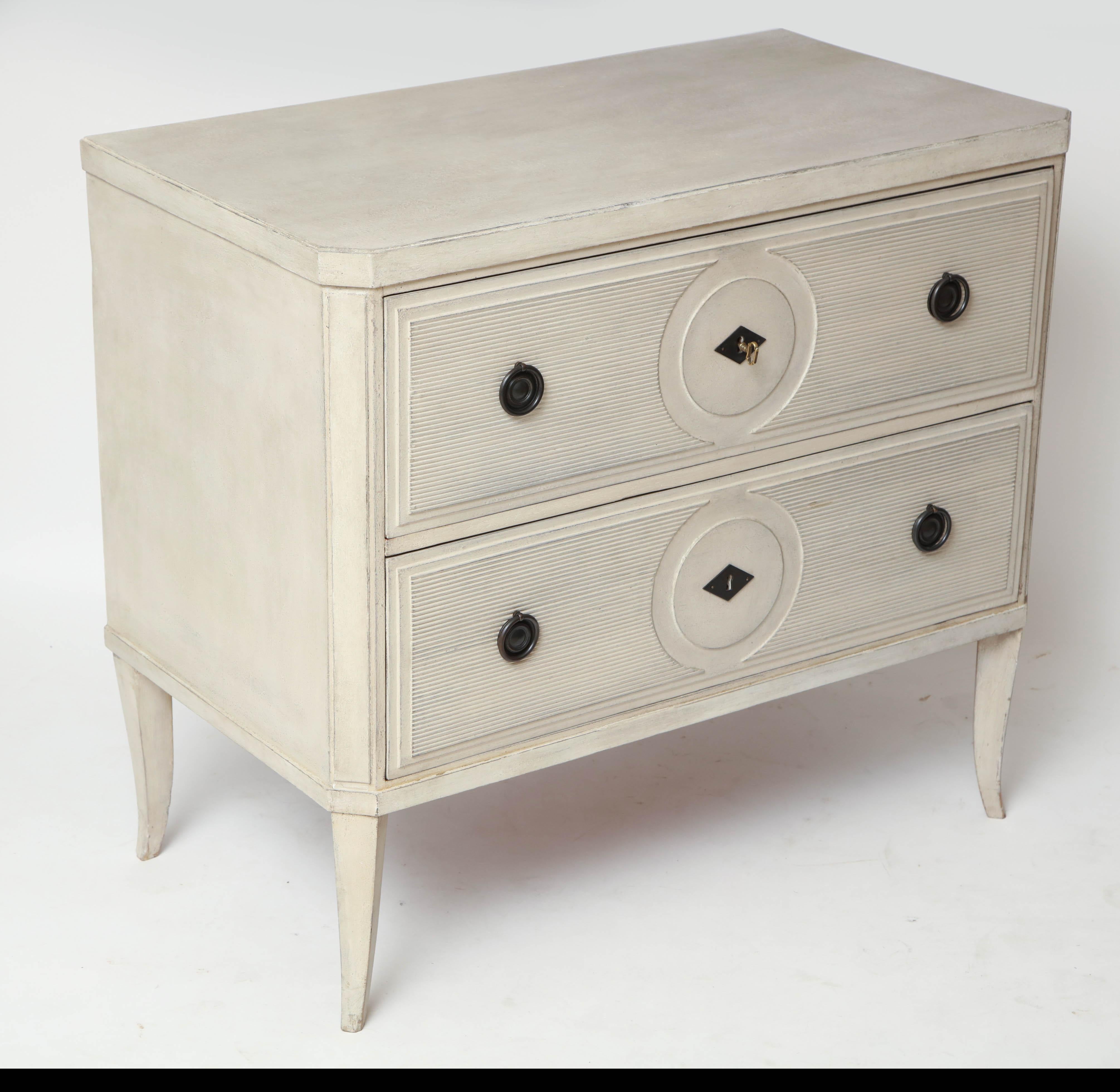 Hand-painted white two-drawer commode with ribbed detailing, Belgium, circa 1950

Overall Dimensions: 38” W, 21” D, 33.5” H

Available to see in our NYC Showroom 
BK Antiques
306 East 61st St. 2nd fl.
New York, NY 10065