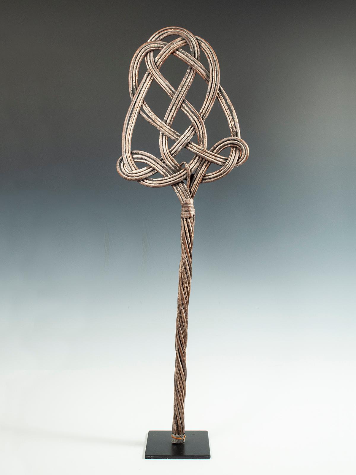 20th century woven cane fabric beater from the Lega People of D. R. Congo

A sculptural piece of African utilitarian ware used to beat the dust out of fabric as it would hang on a line. There are remnants of white paint and it is sold mounted on a