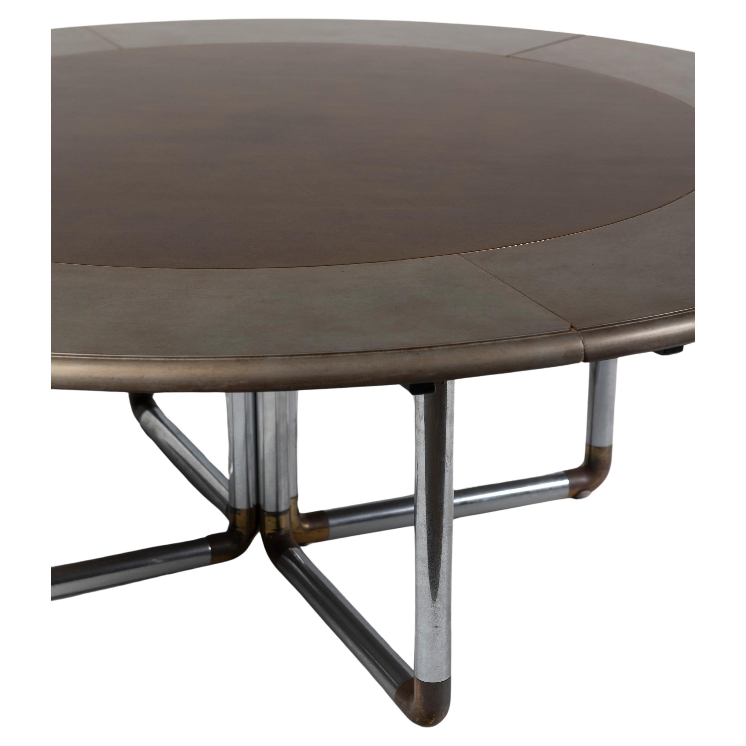 Super modern round dining table is of painted wood top and tubular chrome  with brass detailed base, measures 84
