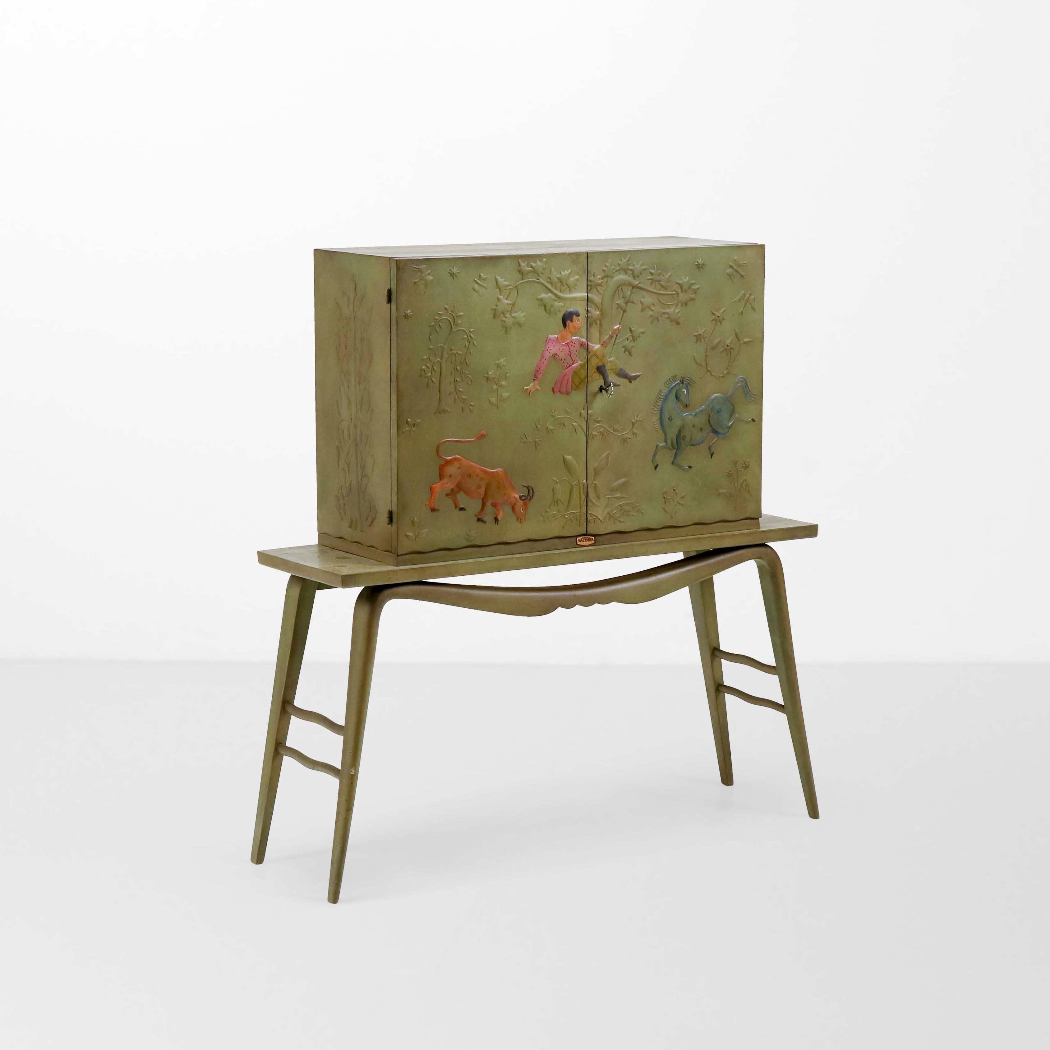 The Valtorta bar cabinet is a luxurious masterpiece, marrying functionality with artistic flair. Inside, a mirrored interior adds glamour, while outside, adorned with bucolic illustrations, it becomes a visual delight. This piece created by Valtorta