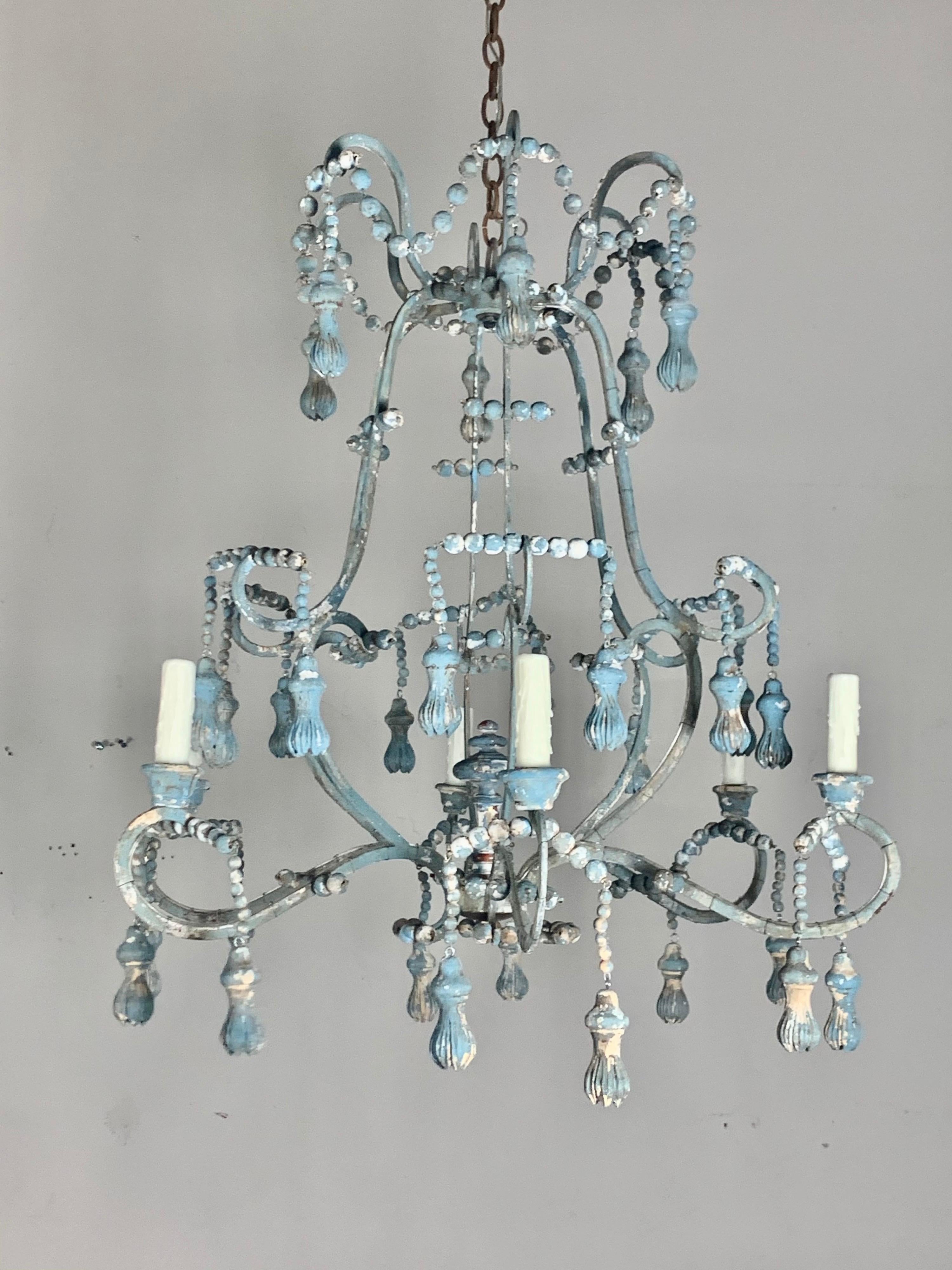 Hand crafted wood & metal painted 6-light chandelier with wood beads and unique carved tassels hanging throughout. The hand painted finish is done over time in the antique artisan style. We can also make this fixture in a natural wood, silver, gold