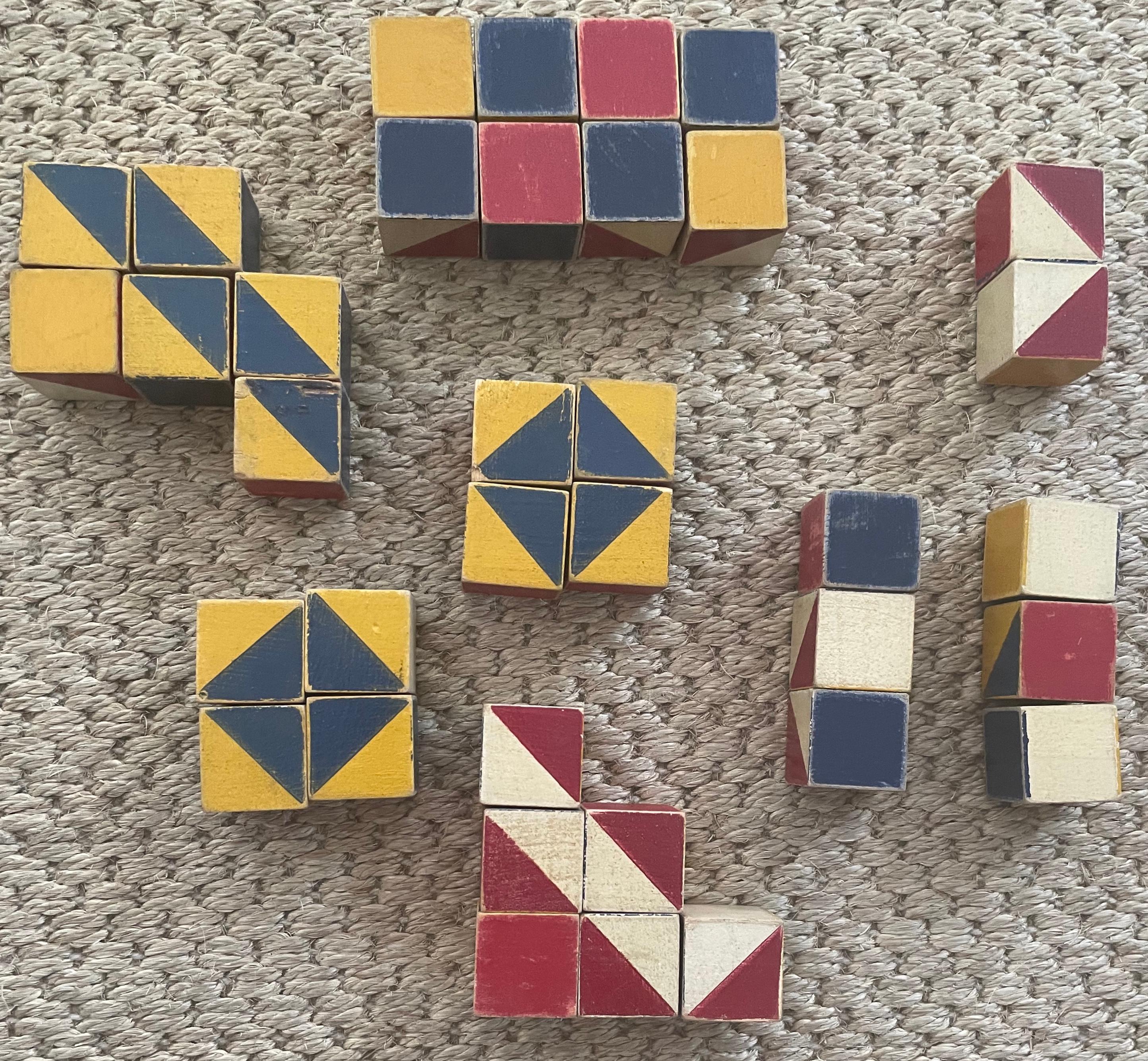 Painted wood design blocks. Multiple diverse and amusing design variations available from painted 1” wood blocks in yellow, red, white blue, and coloured stripes 
United States, midcentury.
Dimensions: each block is 1