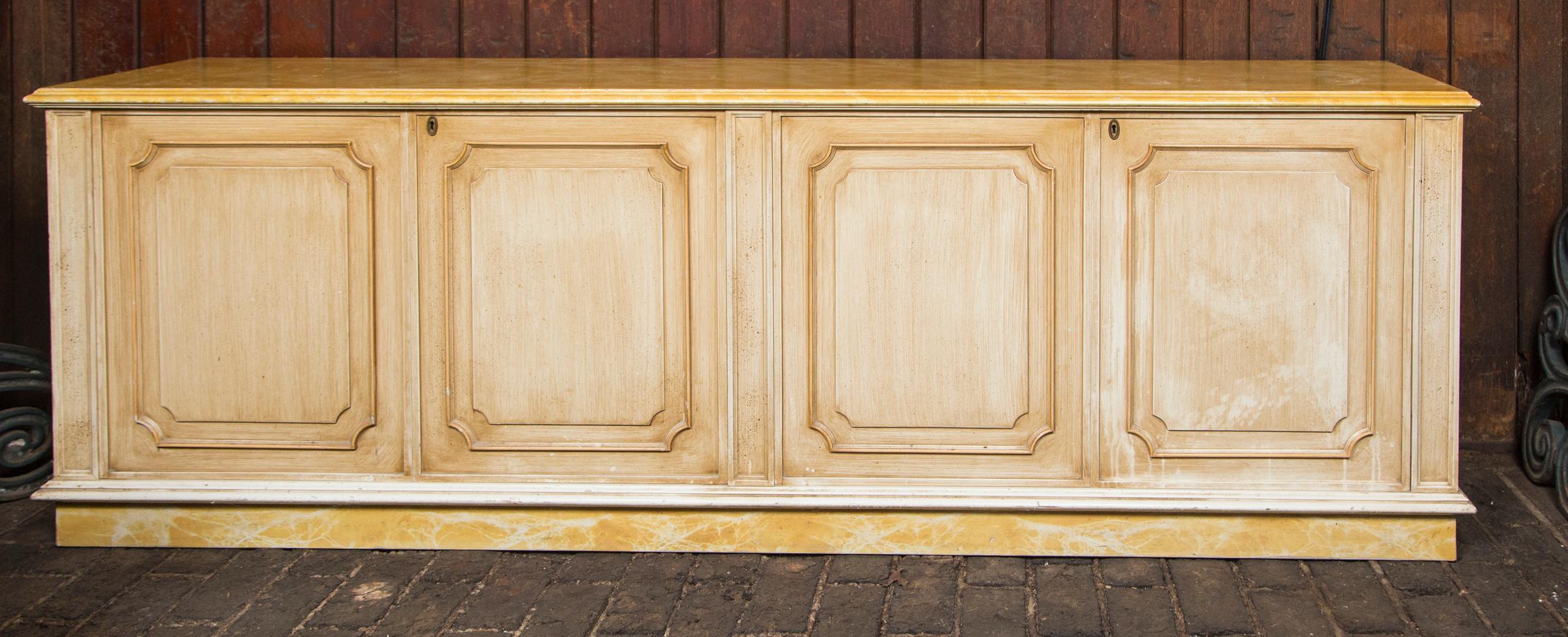 Large gold and yellow painted credenza with two bifold doors from France.