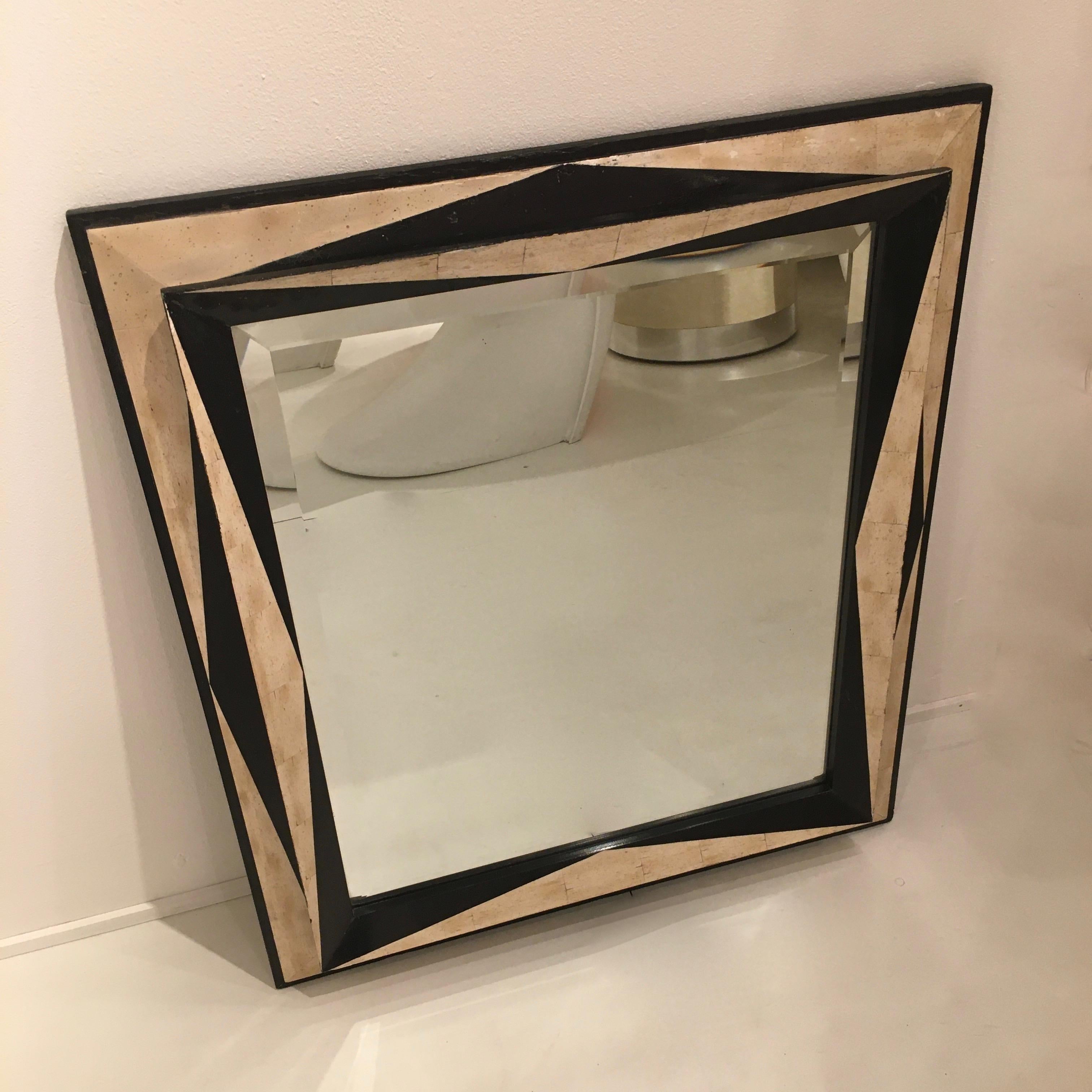 Unusual beveled mirror with a asymmetrical painted wood frame.
Geometrics black forms and bone trompe l'oeil background.
Attributed to Emiel Veraneman, Belgium around 1975.
