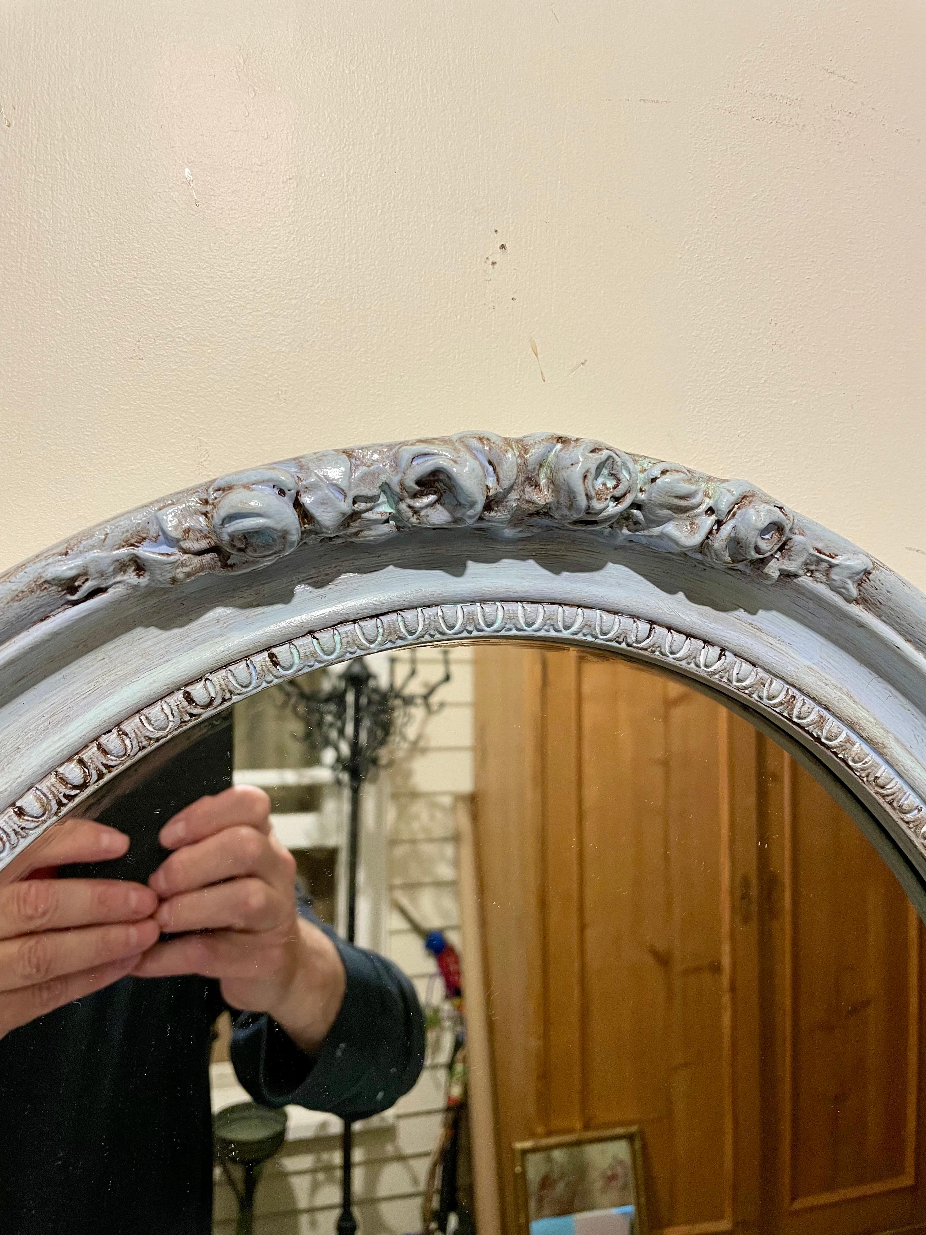 Painted  oval mirror  Nice blueish-green paint finish in the Hollywood Regency style. Has wire and is ready for hanging. Great scale. Mirror frame looks older then the mirror which is marked 1983. Overall good condition. Can be professionally packed