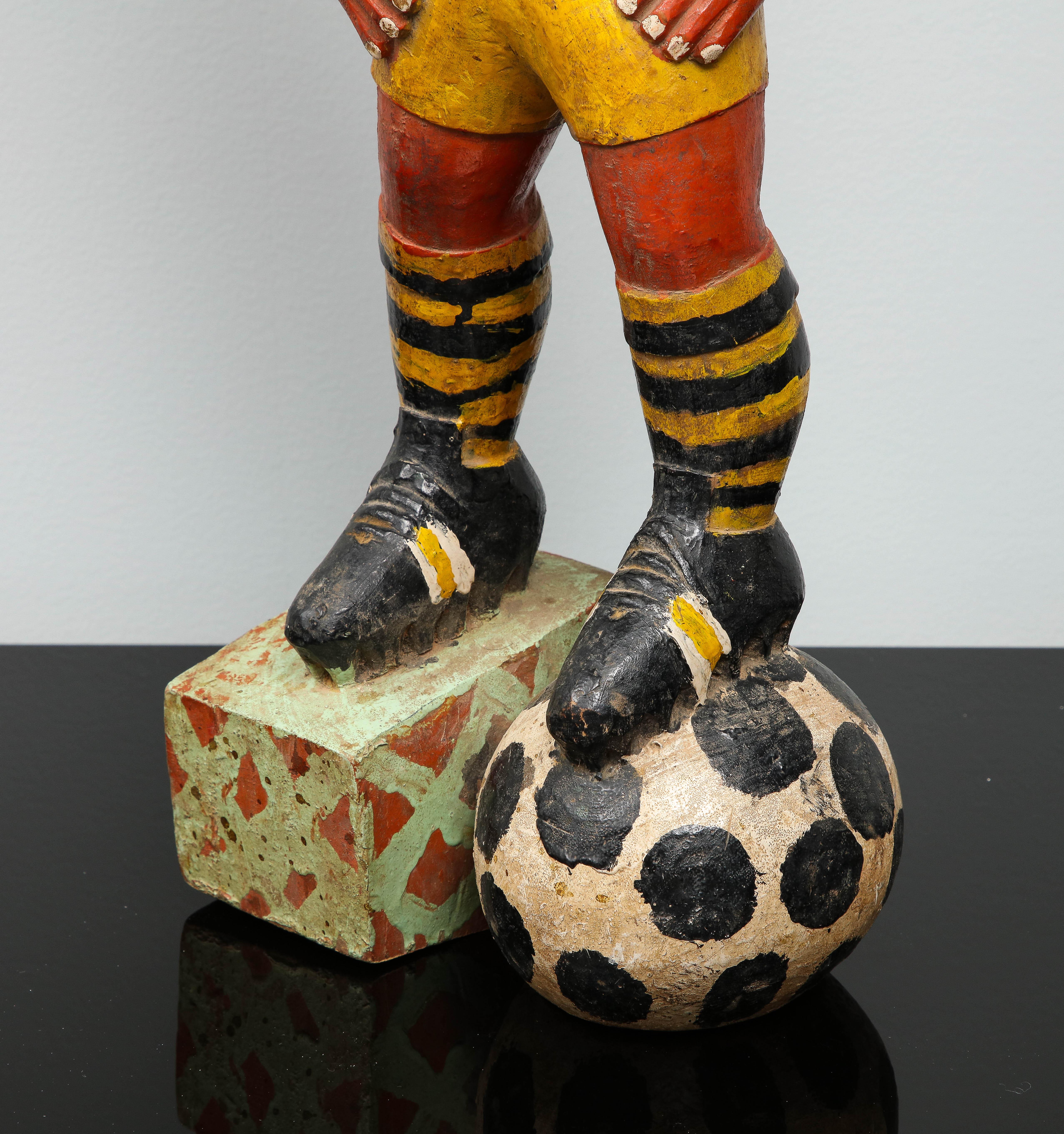 Late 20th Century Painted wood sculpture of a soccer player