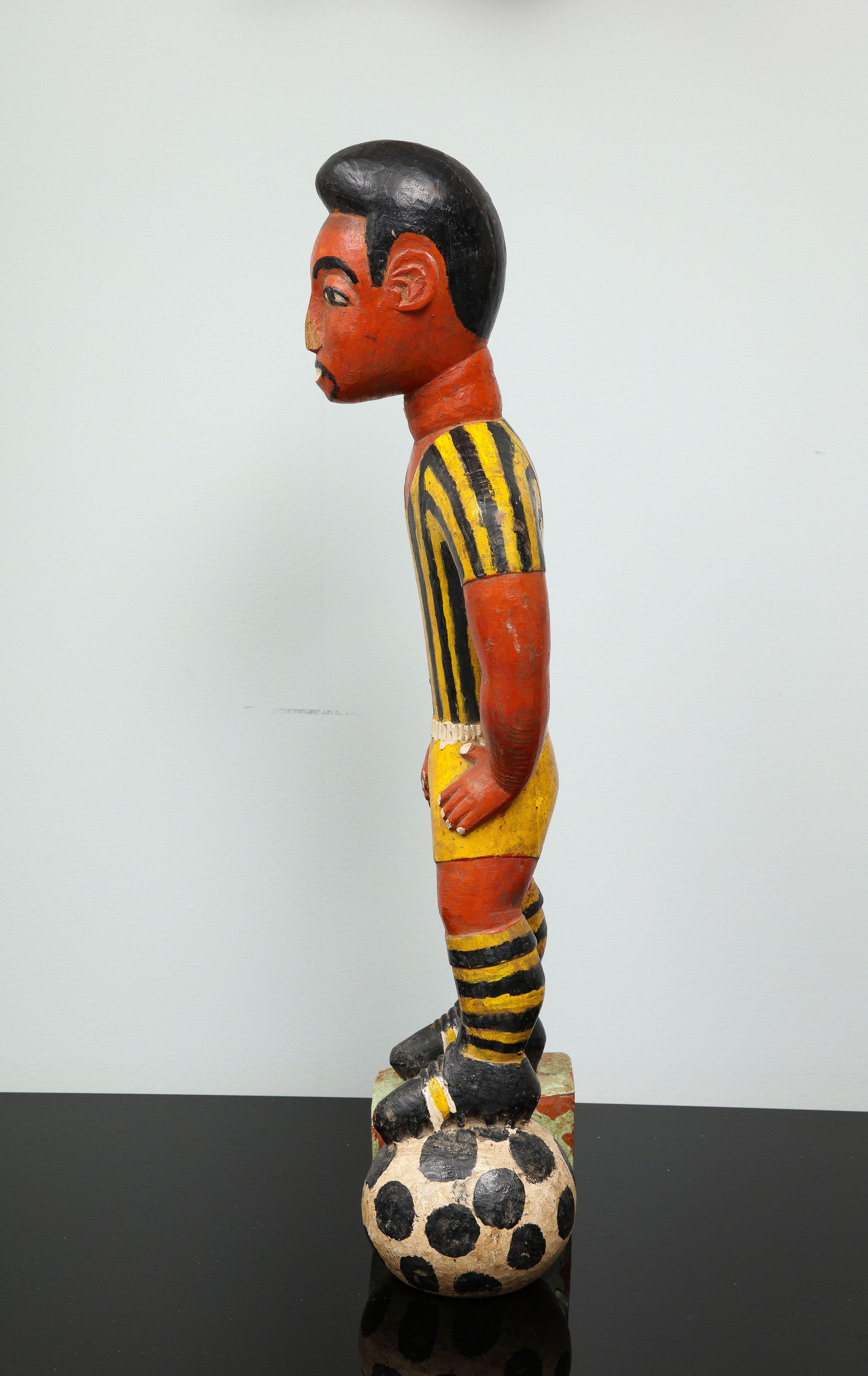 Painted wood sculpture of a soccer player 1