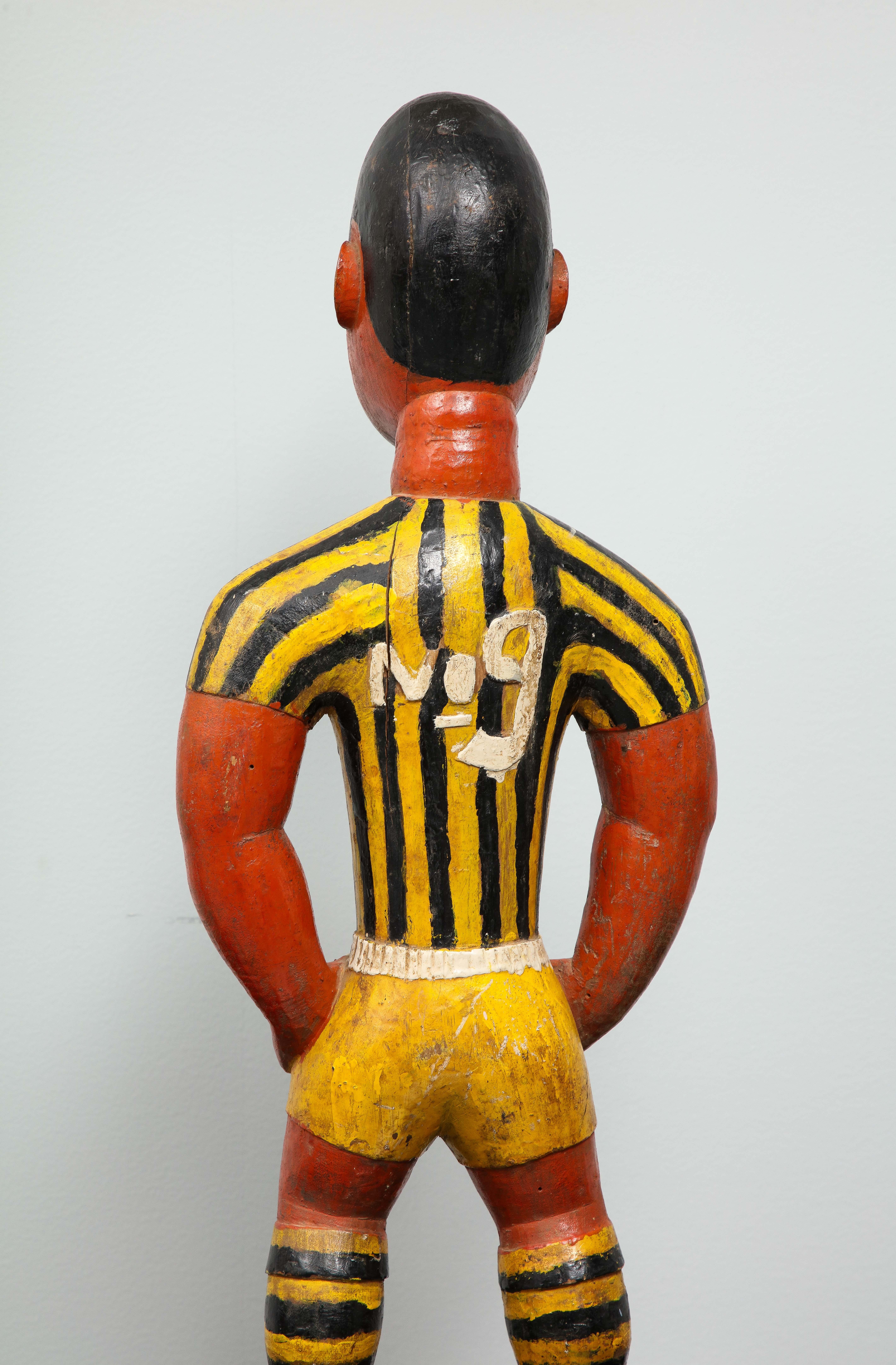 Painted wood sculpture of a soccer player 3
