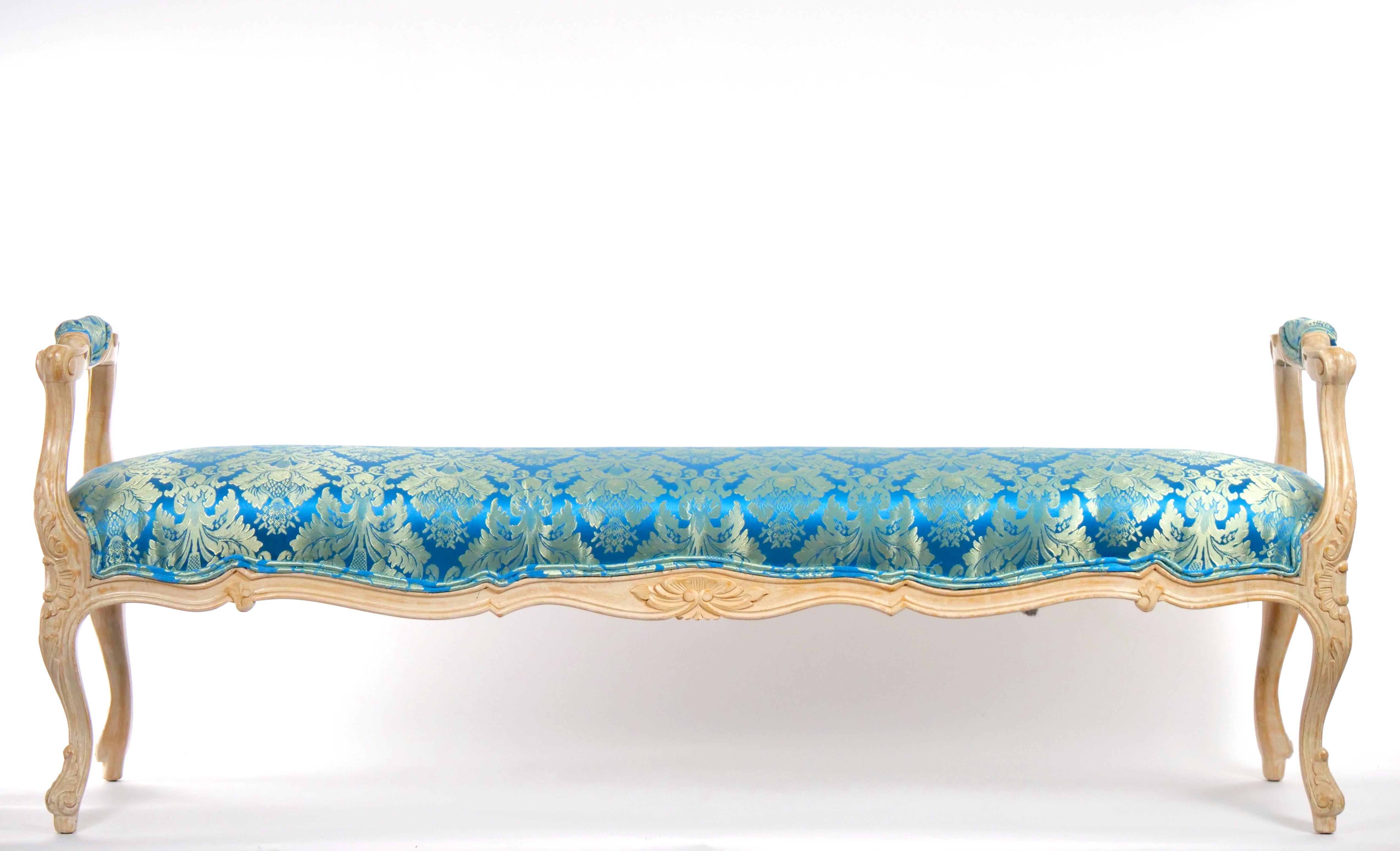 Beautiful Italian Louis XVI style painted wooden frame and hand decorated floral design bench with silk damask blend upholstered seat from the mid century. This bench features hand carved fluted details to the arm rails and legs. The arms are padded
