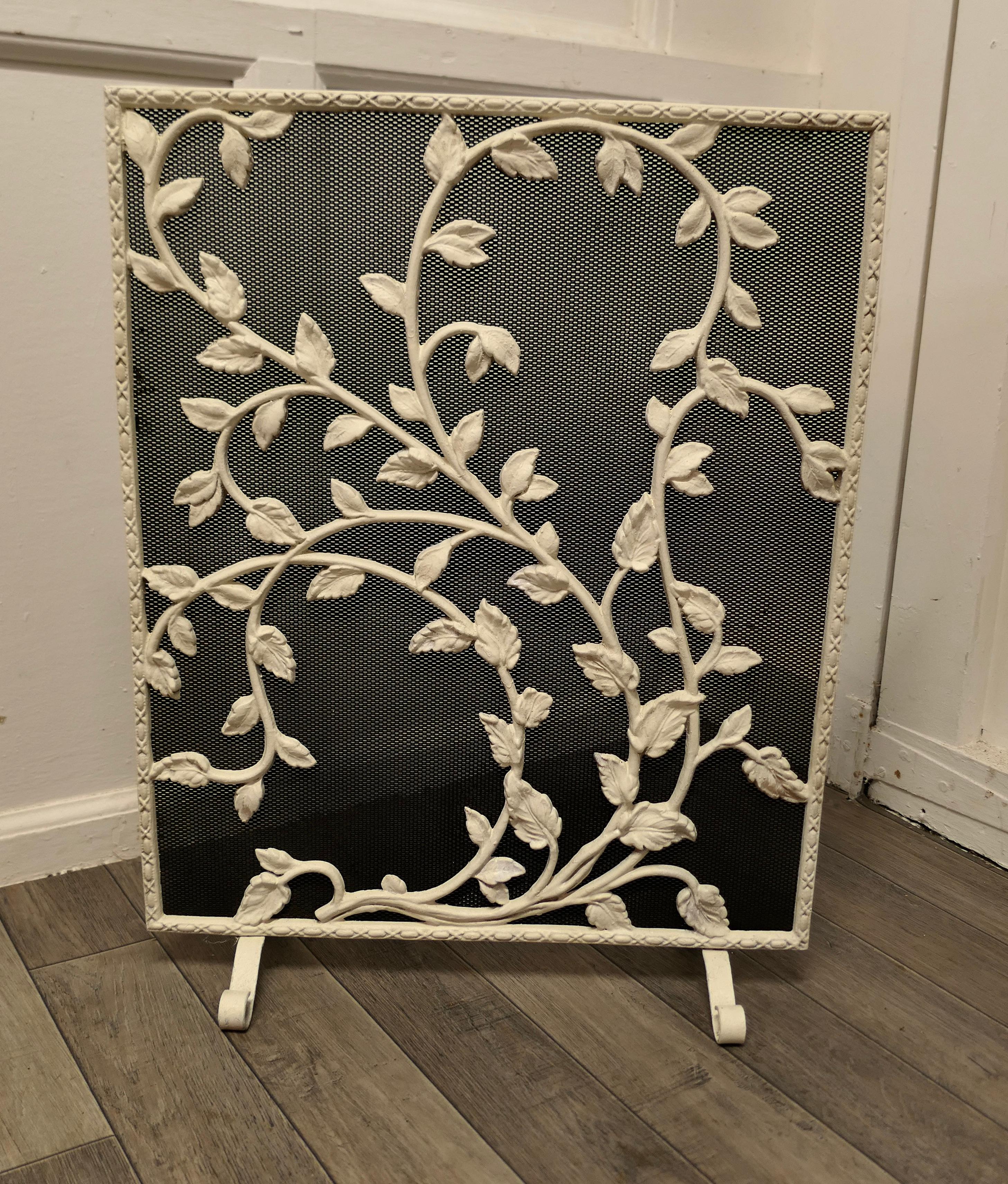 Painted wrought iron fire guard decorated with leaves.

This is a good Fireguard, it has a decorative wrought iron decoration over heavy inset mesh 
The guard is in good condition and very steady when in use
It is 26” high, 20” long 
TJK225