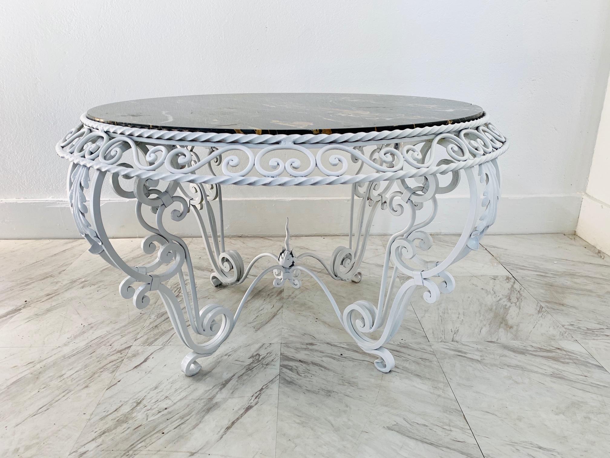 Painted wrought iron marble-top coffee table in the manner of Gilbert Poillerat.