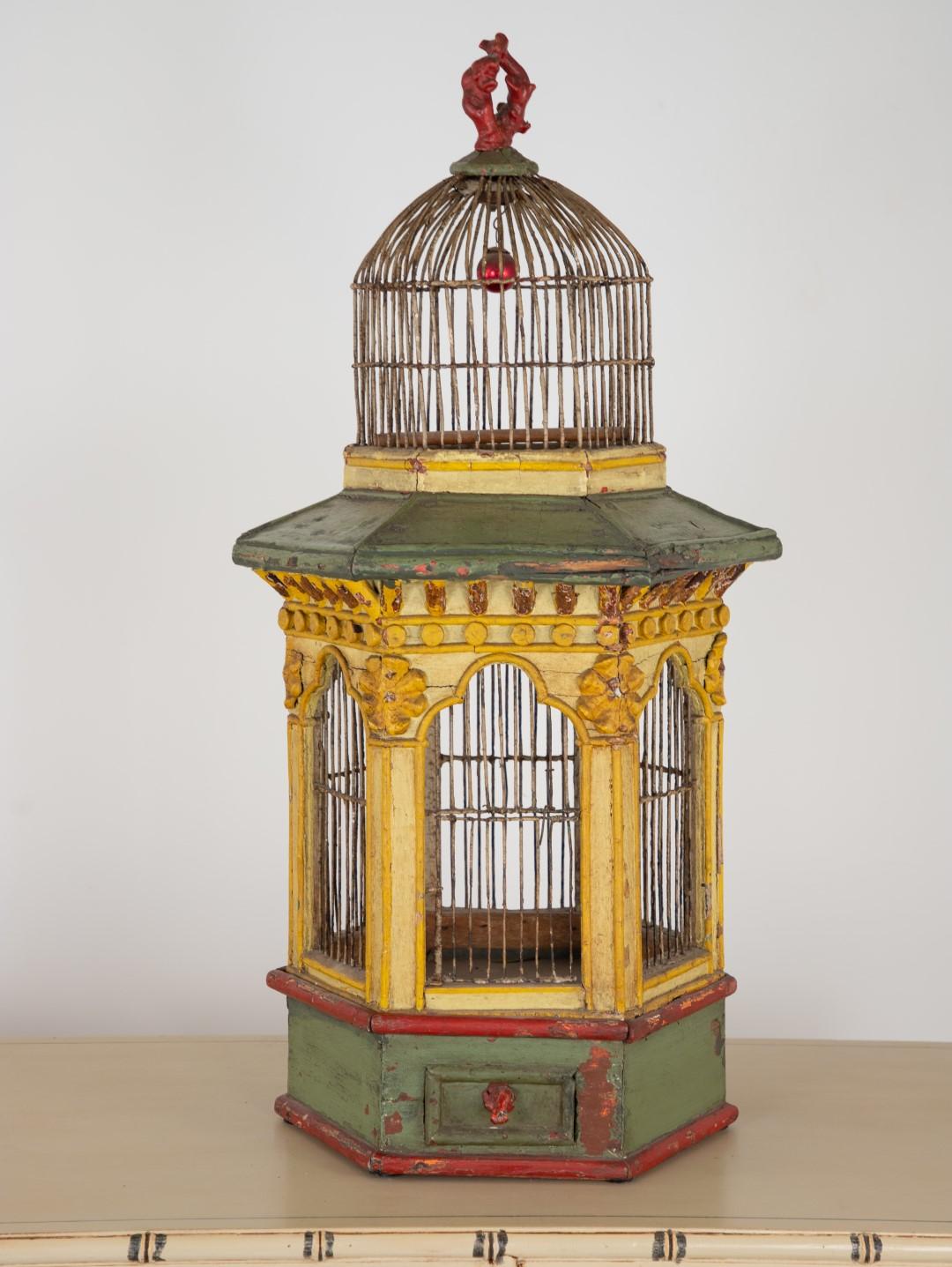 An English polychrome yellow, green, and red painted wire pagoda birdcage, circa 1820.