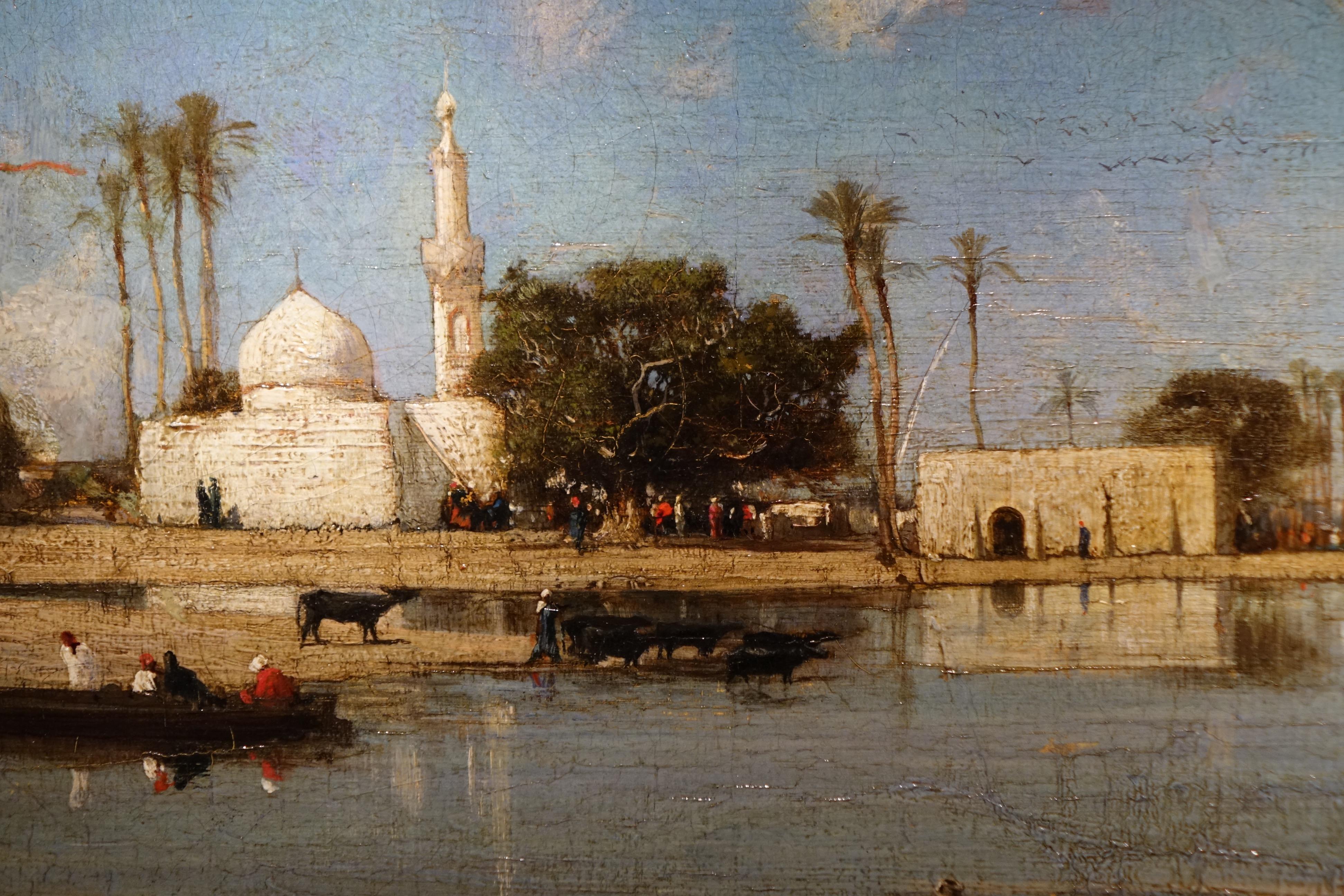 Banks of the Nile, painting signed Victor Hughet (1835-1902) 
Oil on canvas depicting the banks of the Nile, which is certified by a label on the back, with a number 368.
The location is unknown, but we see three groups of people, two of which
