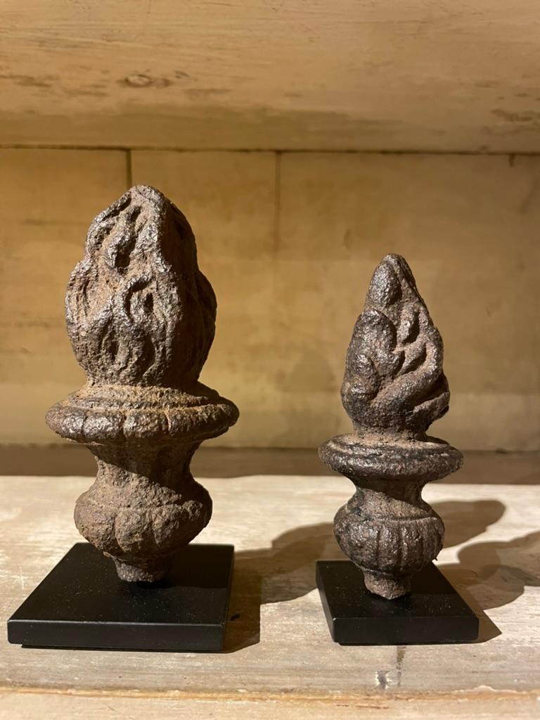 Two wonderful Baroque iron fragments, urns with flames that were once finials, likely architectural ornaments. Beautifully cast iron, evocative despite the small scale. These will make unique decorative accents. Custom mounted on black steel bases.