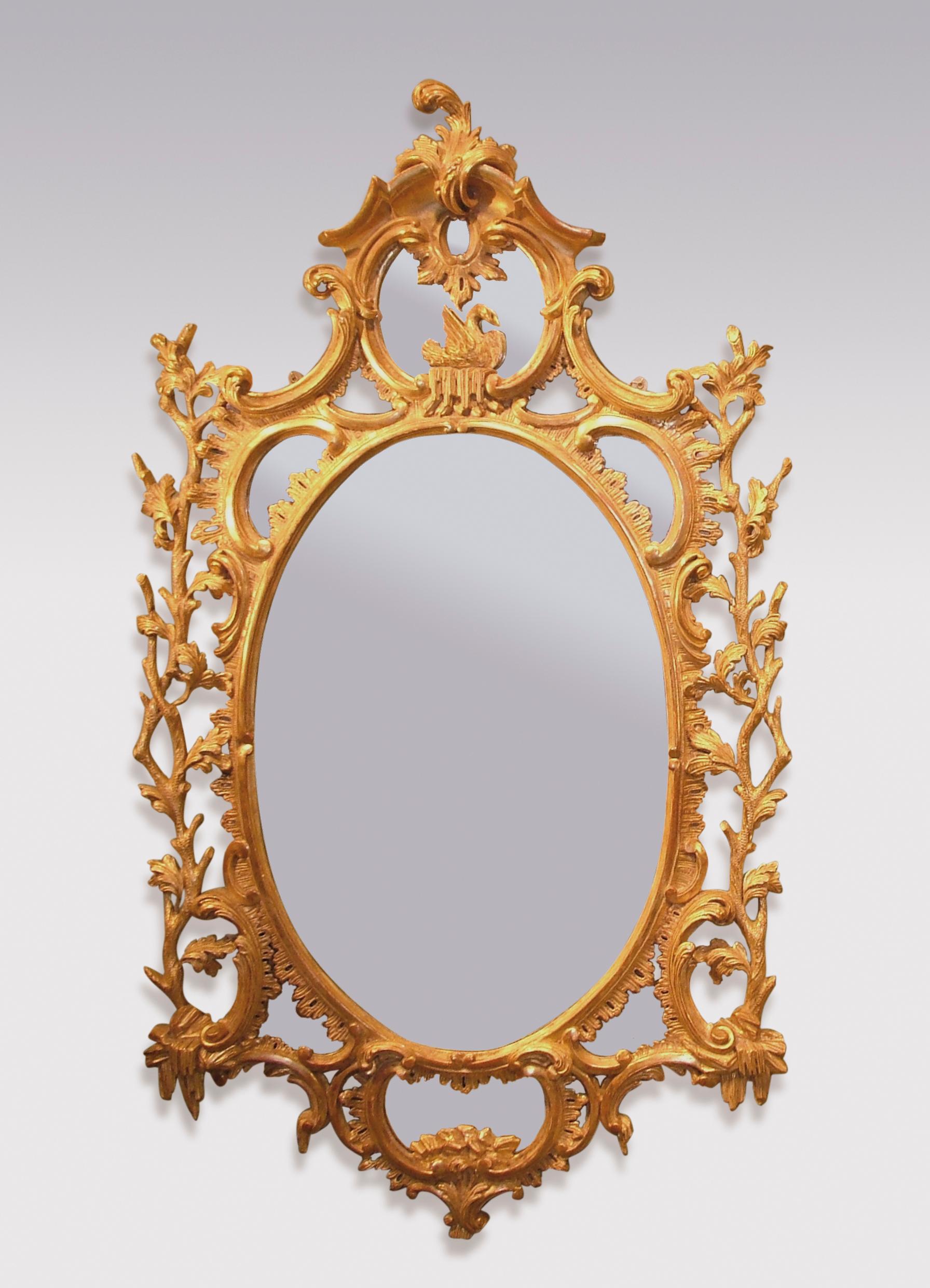 An important pair of mid-18th century period carved giltwood mirrors, having oval centres surmounted by scrolled and corniced panels with swans. The Mirrors decorated with C-scrolls, leaves and branches, with oval panels with rock decoration below.