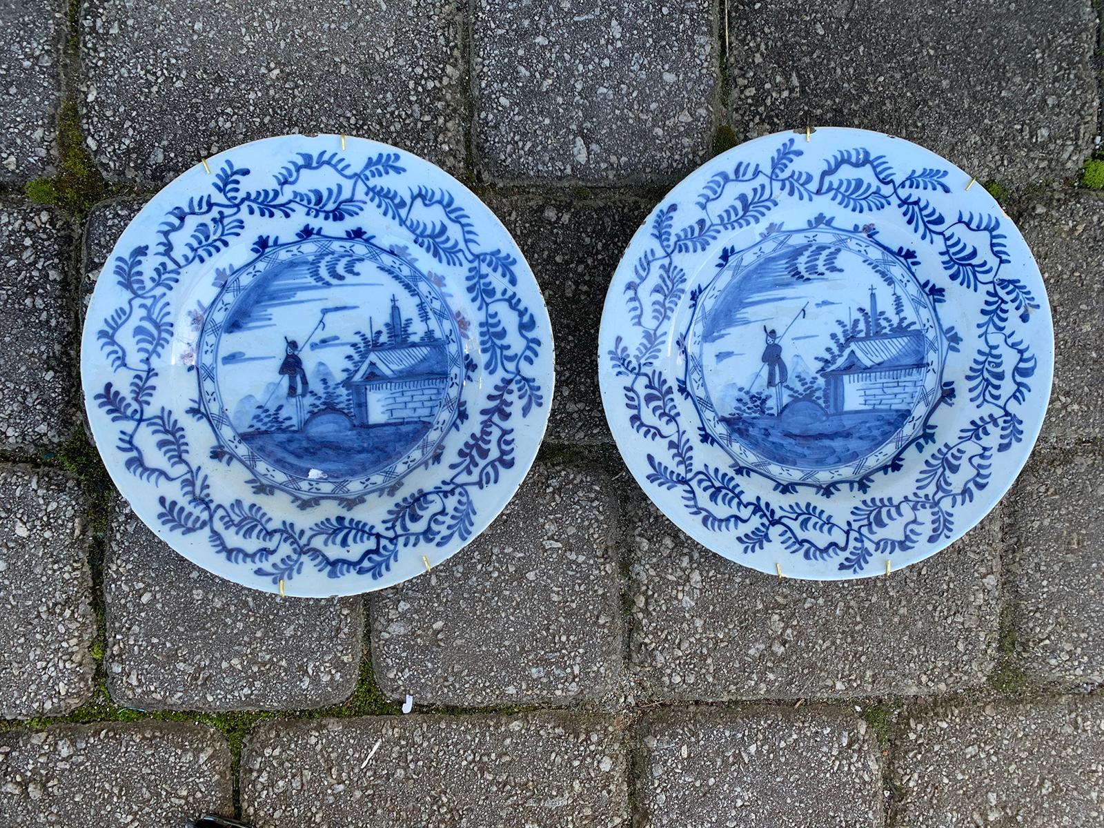 Pair of 18th century delft style blue and white plates with fisherman.