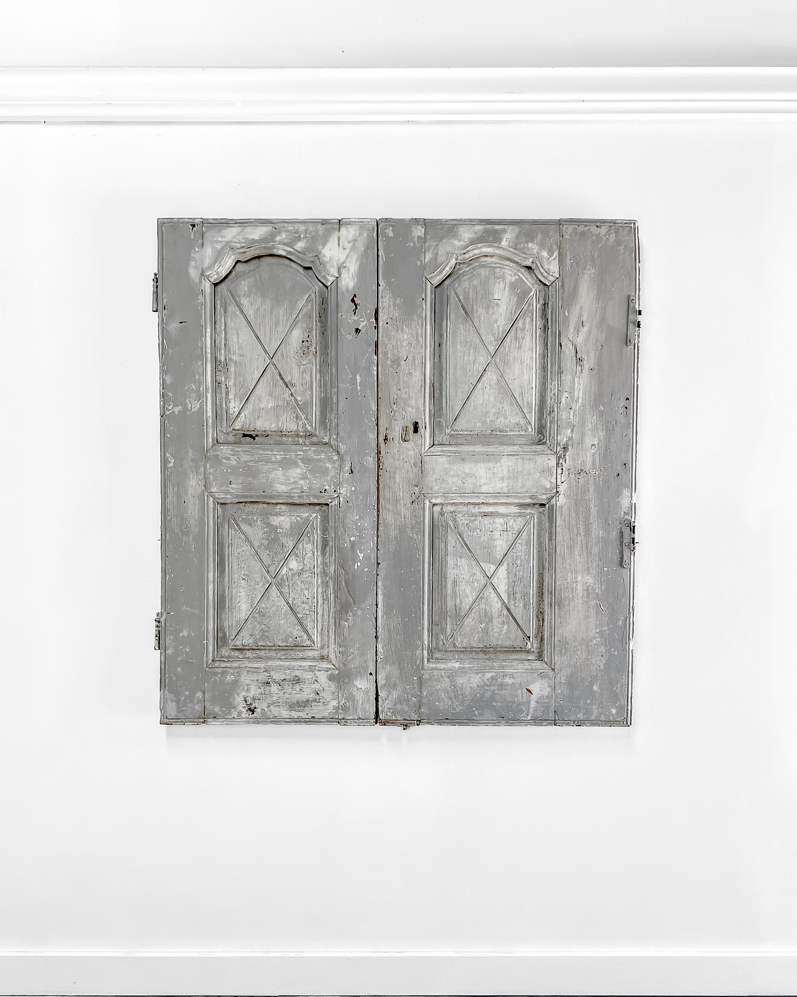 A pair of reclaimed provincial paneled cupboard doors with wonderful X-decoration details. Enclose a built-in cabinet with this charming pair of doors to feel as if you’ve been transported to the French countryside.

Salvaged in France, circa