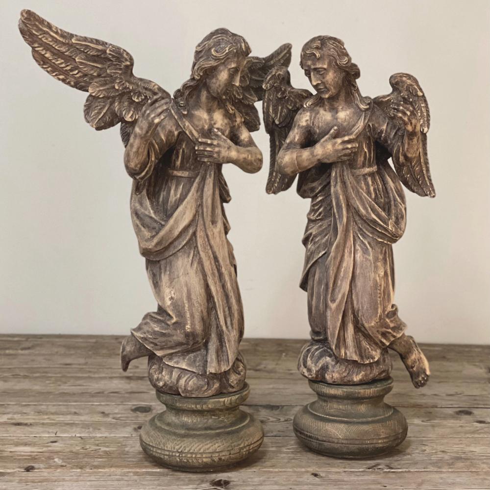 Pair 18th century hand-carved wooden angels were sculpted by a talented artist from solid blocks of hardwood, and feature exquisite features and detail! One angel appears with outspread wings, while the others are folded. Each has a pensive,