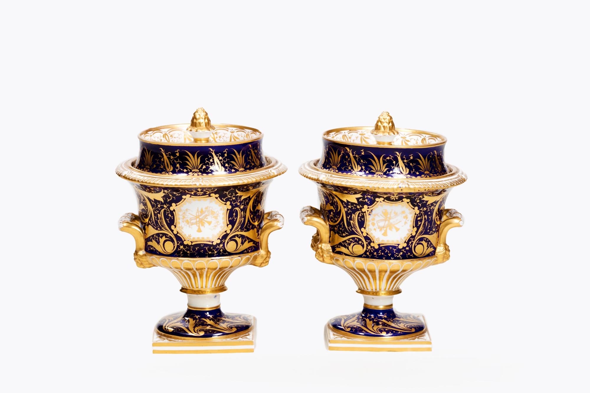 Pair 18th Century Royal Worcester lidded ice pails handpainted with views of Portsmouth Harbour. This pair with acorn finials to the covers and scrolled handles either side of the body are fished with delicate swirling gilt details featuring bands