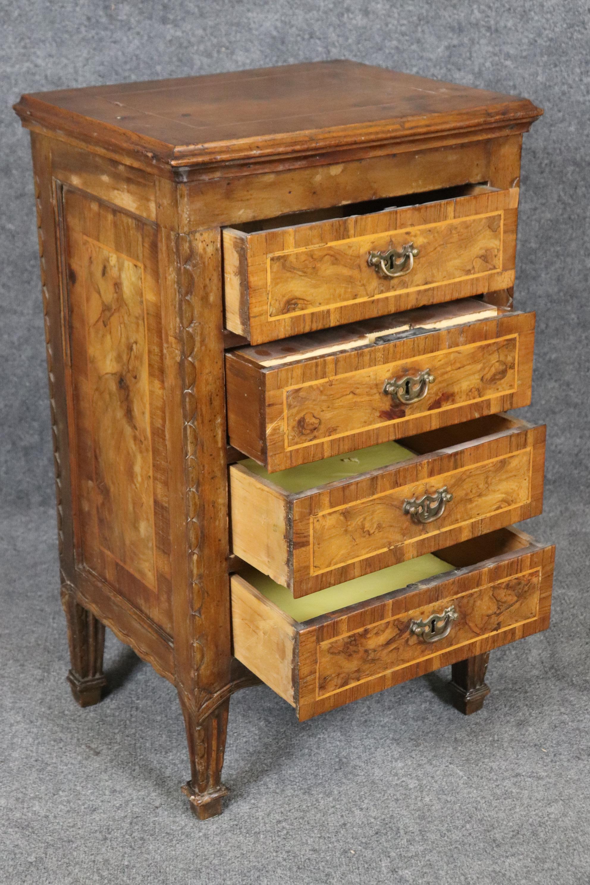This is a fantastic and rare pair of pine and olivewood veneered 1790s era nightstands from Italy. The stands feature chunky antique locks and gorgeous patina and signs of old-world craftsmanship that's indiciative of the Italian country style. The