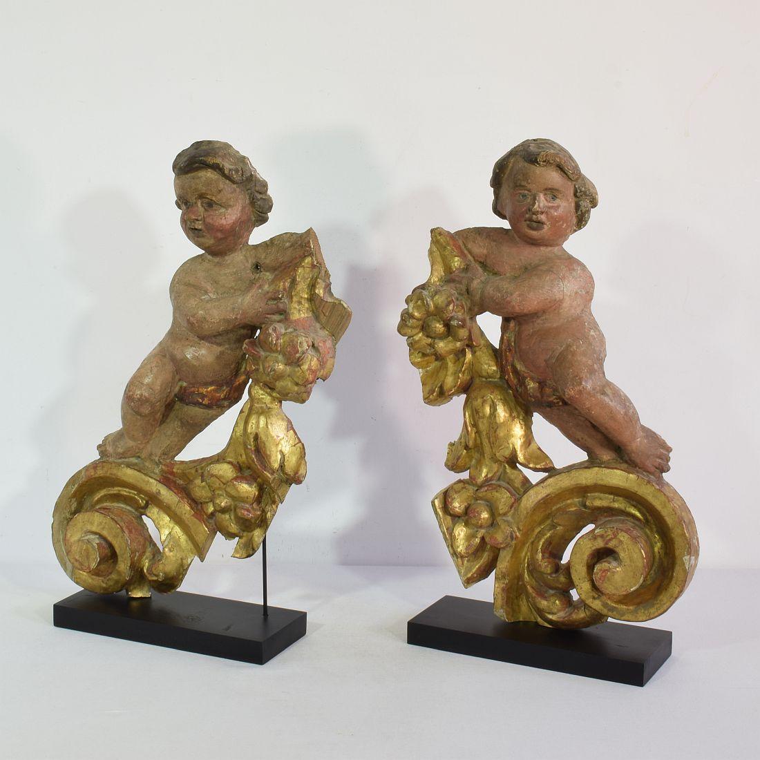 Stunning pair of carved wooden Baroque angel fragments in a beautiful naive style.
Unique period pieces. 
Italy, circa 1700-1750. Weathered, small losses and old repairs.
Measurements are individual.