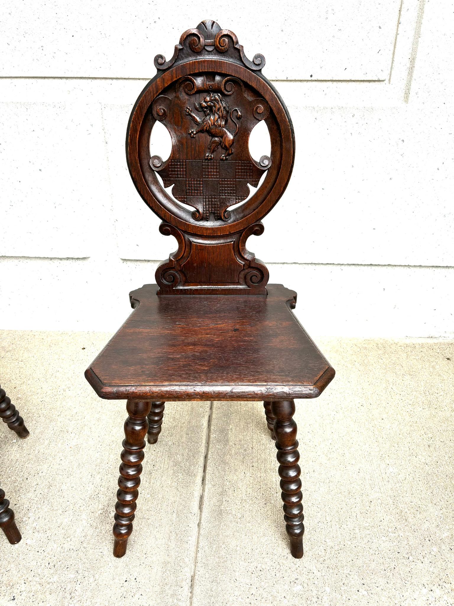 Baroque Pair 18th Century Italian Chestnut Hall Chairs Carved With Lion Crests  For Sale