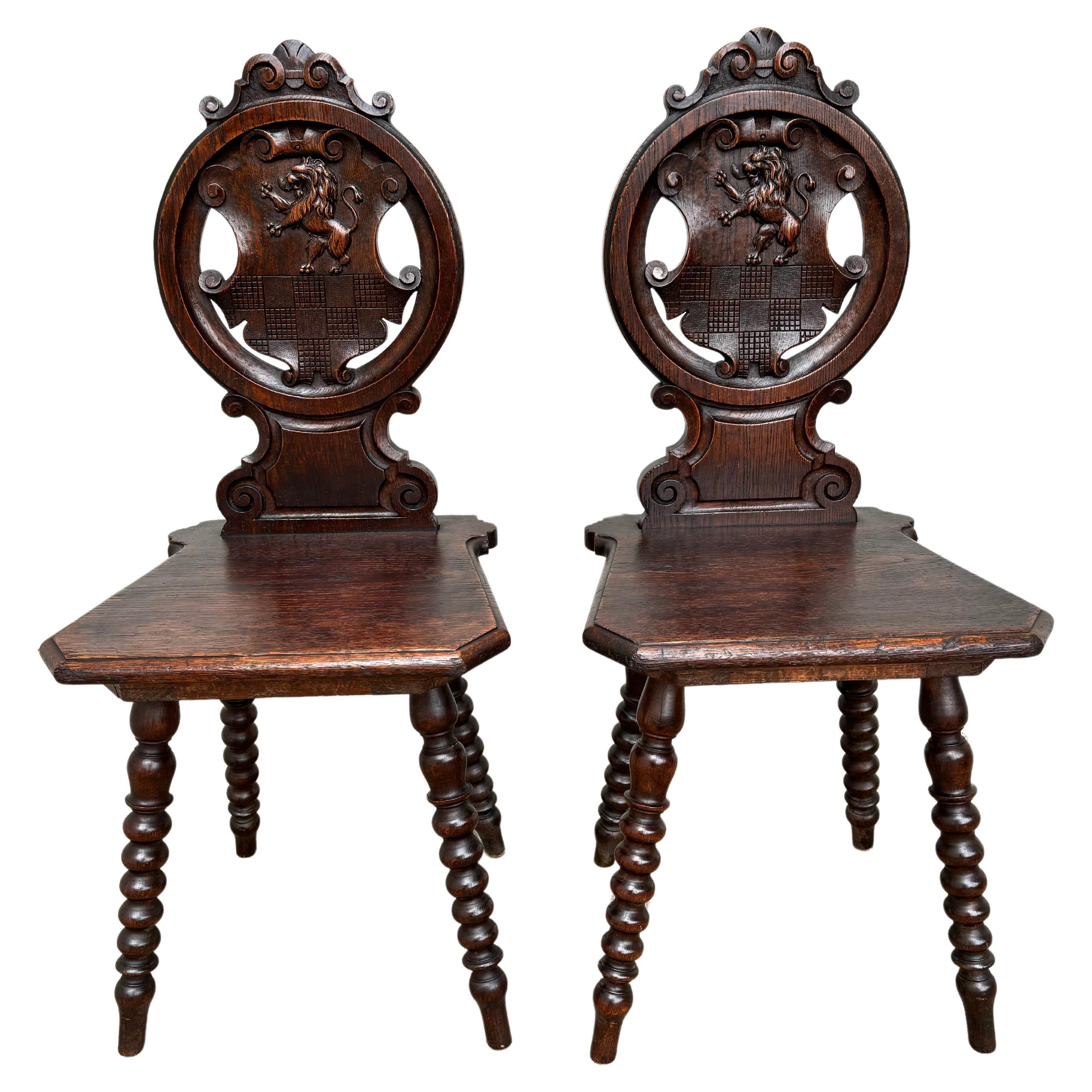 Pair 18th Century Italian Chestnut Hall Chairs Carved With Lion Crests  For Sale