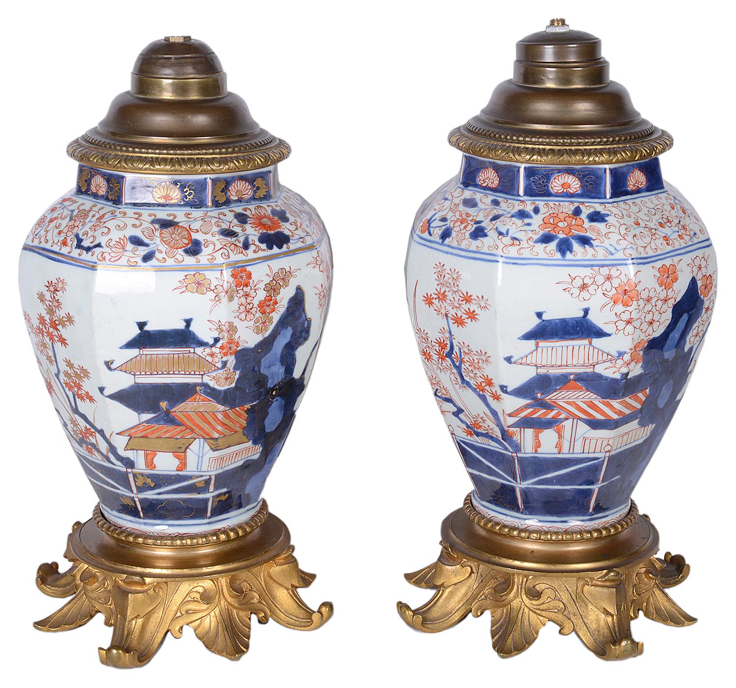A good quality pair of late 18th century Japanese Imari vases / lamps. Each with classical pagoda building, exotic flowers and birds, raised on out swepted ormolu bases.