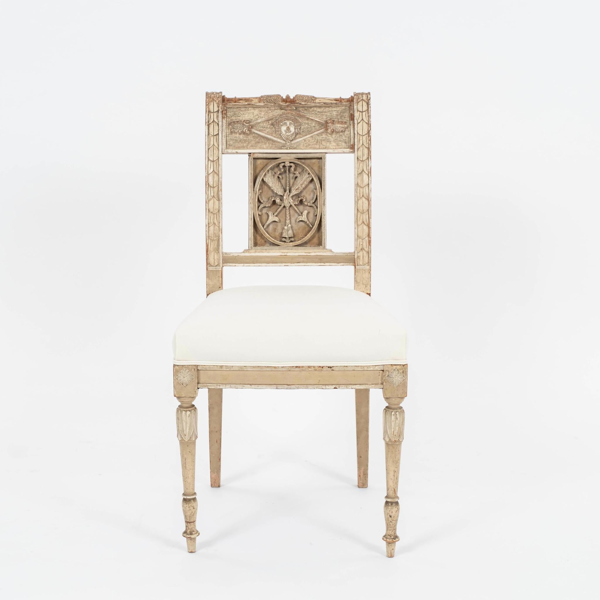 Pair 18th Century Gustavian chairs: beautifully carved, scraped painted adorned with exceptional Neoclassical motif decoration. Newly upholstered in ticking.
Four available and sold by the pair in this listing.
