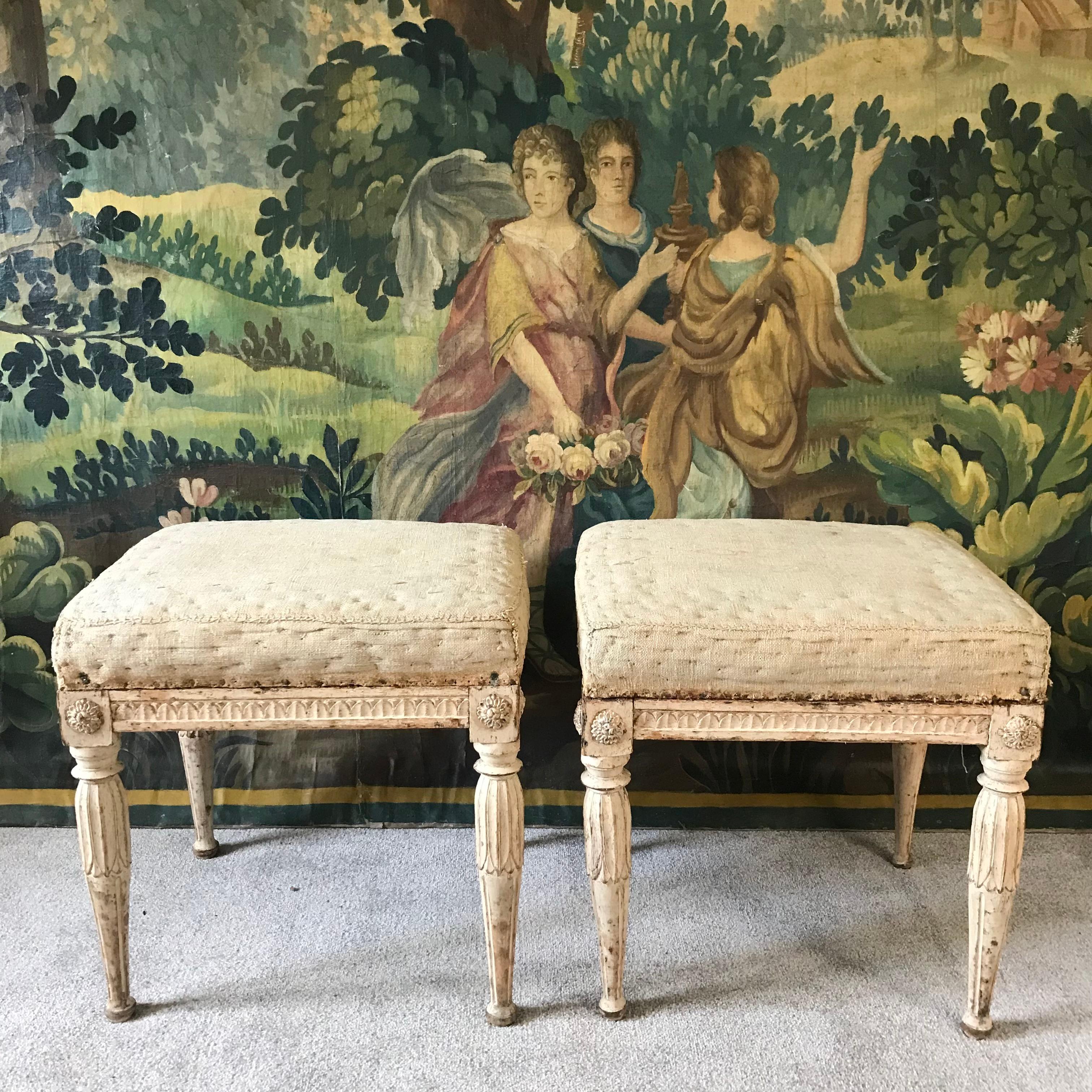 A particularly good pair of Swedish period Gustavian stools in original dark cream paint - fine hand carved details on all four sides - these are strong and stable for using and are a slightly larger than average size - with original linen burlap