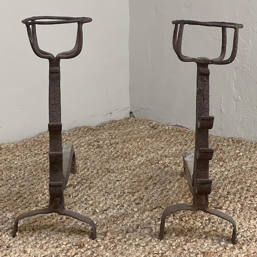 Pair 18th century wrought iron andirons were just as functional as they were decorative back in the days before central heating and electric lighting! Forged and hammered by the local blacksmith, they had little cages on top to set vessels of water