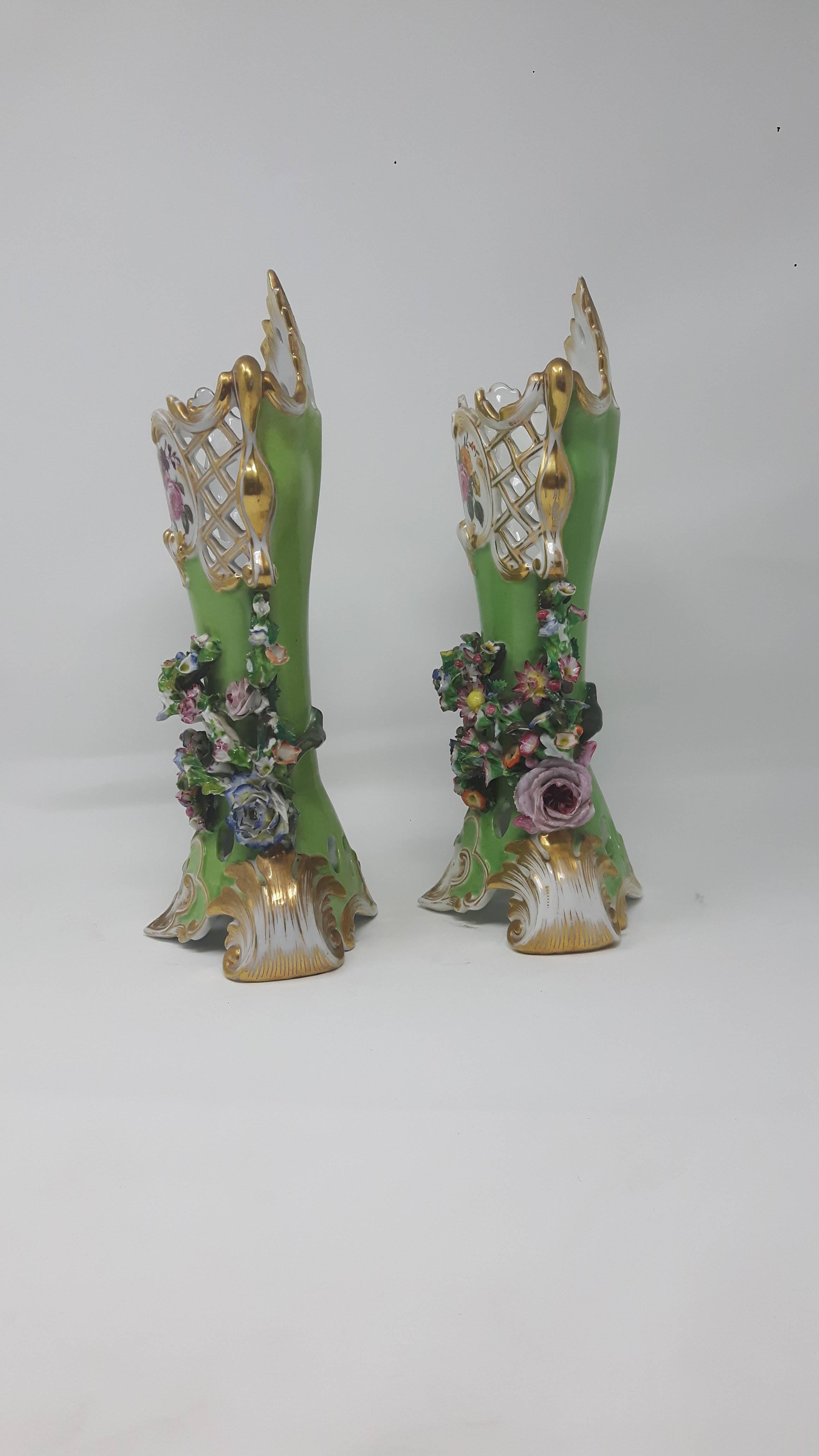 Pair of marked Jacob Peti flower encrusted vases delicately applied with multi-color flowers.