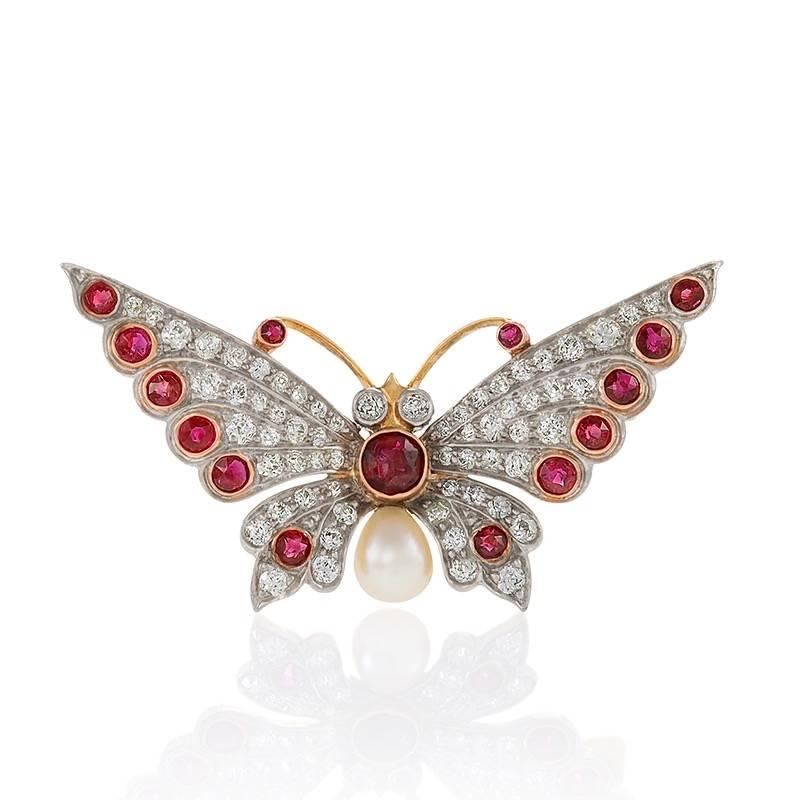 An Early-20th Century pair of 18 karat yellow gold/platinum top butterfly brooches with diamonds, rubies and pearls. The pair of brooches have 120 Old European cut diamonds with an approximate total weight of 3.00 carats, and 30 Old European cut